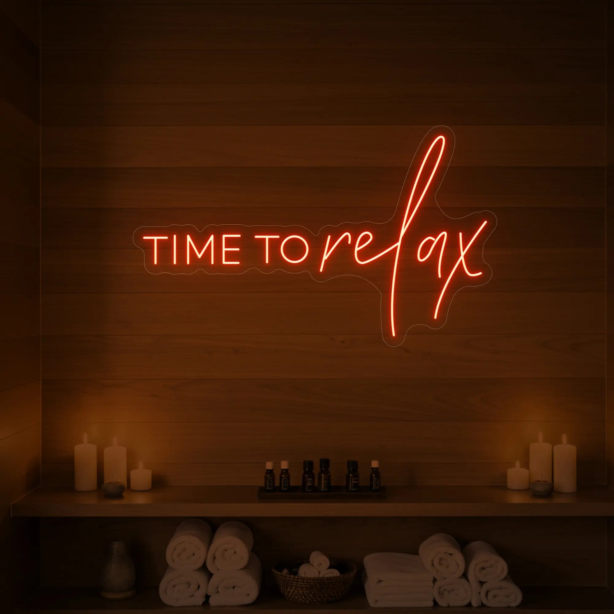 Photo of the 'TIME TO RELAX' neon sign glowing in golden yellow against a styled interior wall.