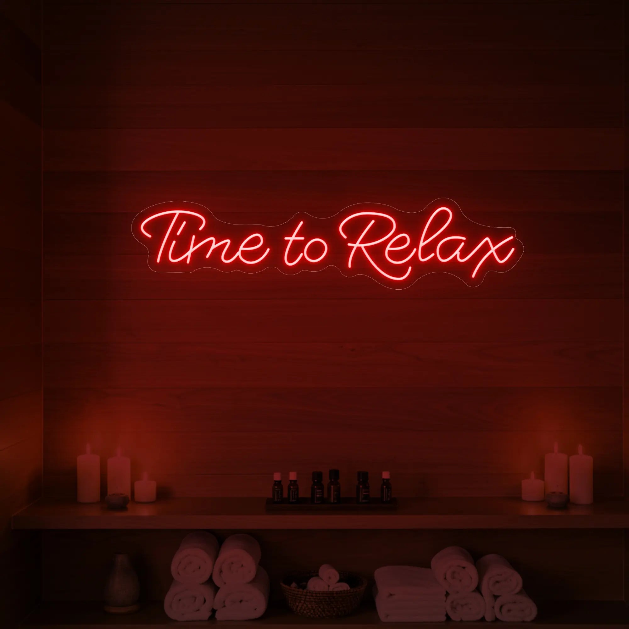 Photo of the 'Time to Relax' neon sign glowing in red against a styled interior wall.