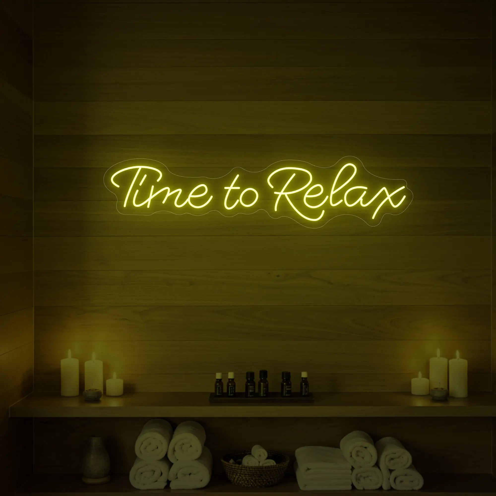 Photo of the 'Time to Relax' neon sign glowing in lemon yellow against a styled interior wall.
