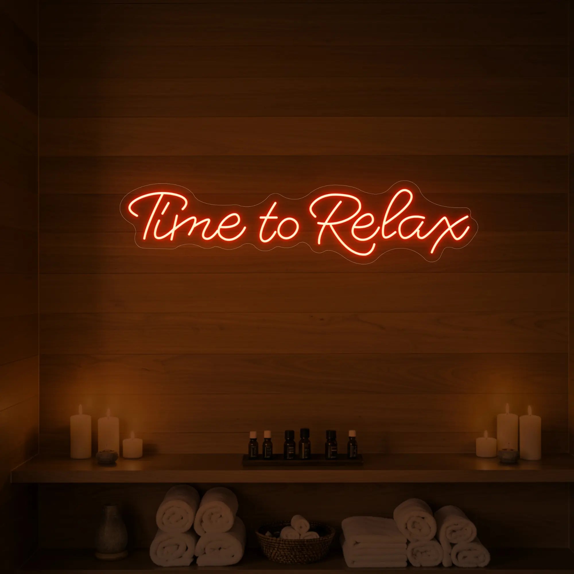 Photo of the 'Time to Relax' neon sign glowing in golden yellow against a styled interior wall.
