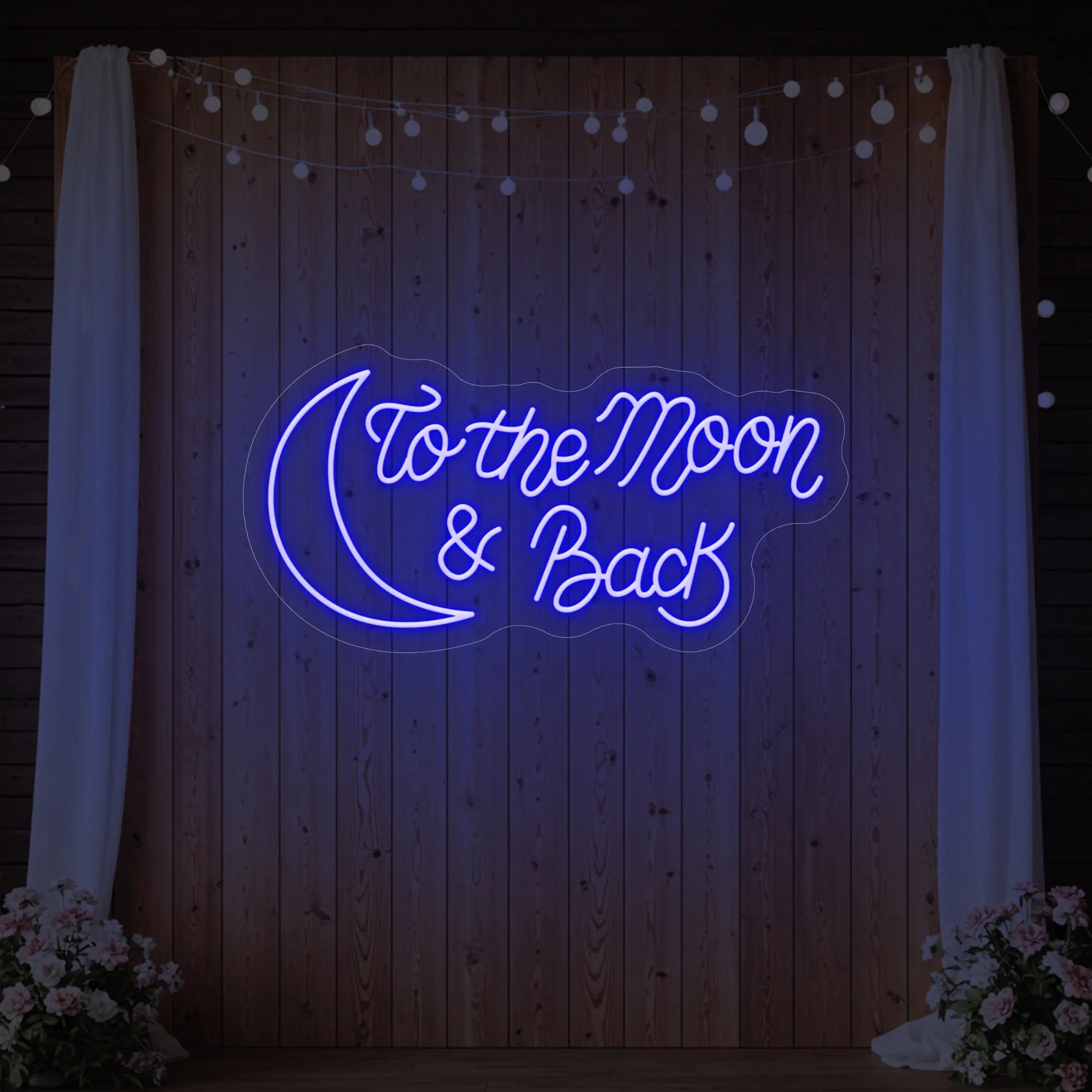 'To The Moon And Back' neon sign glowing in deep blue against a styled interior wall.