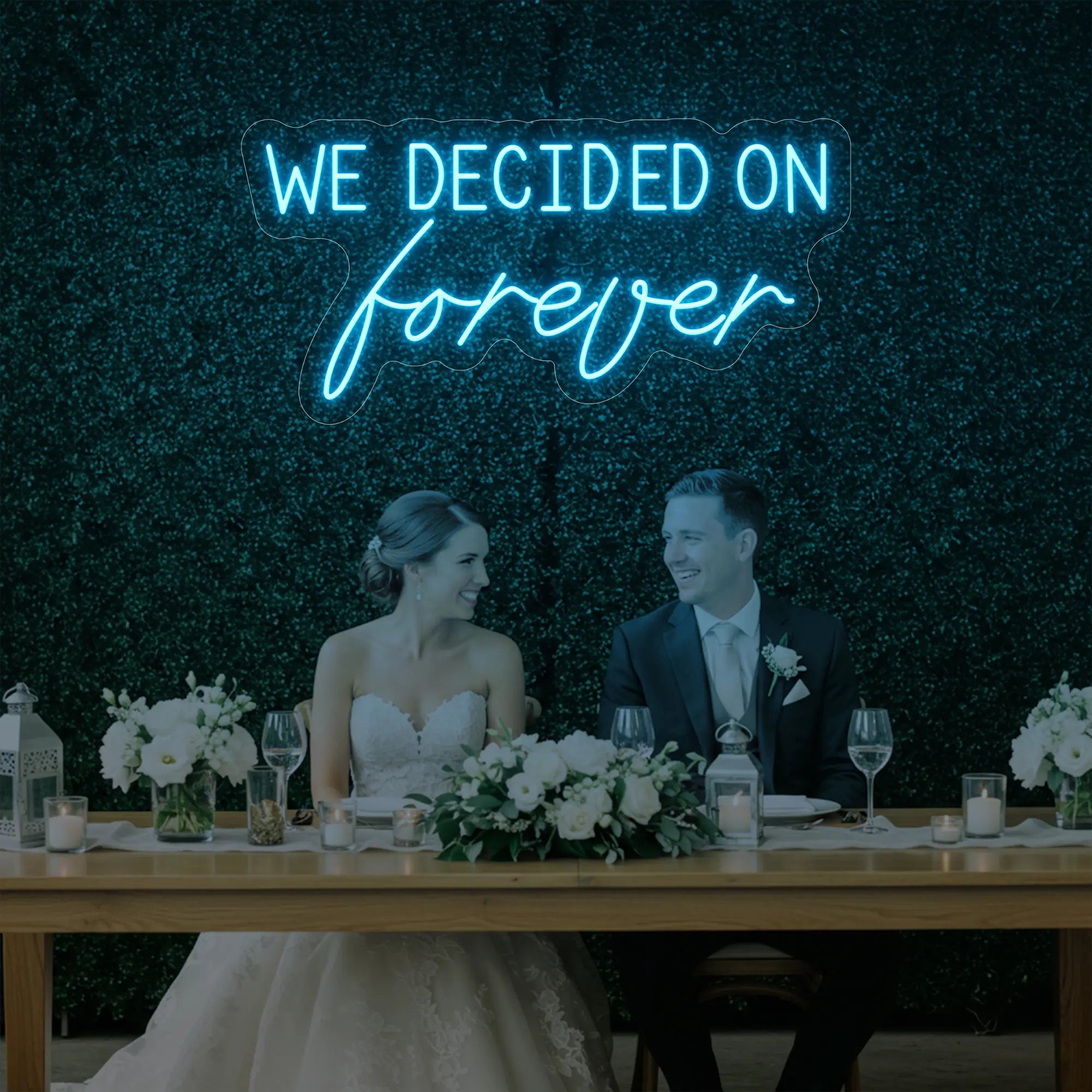 'We Decided On Forever' neon sign glowing in ice blue against a styled interior wall.