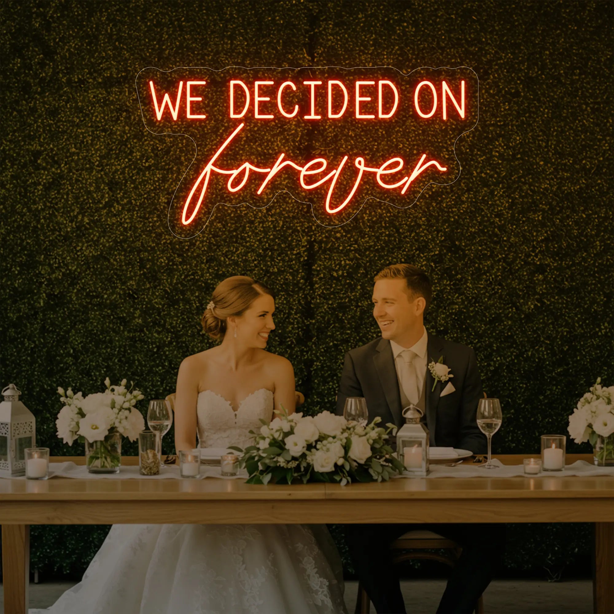 'We Decided On Forever' neon sign glowing in golden yellow against a styled interior wall.