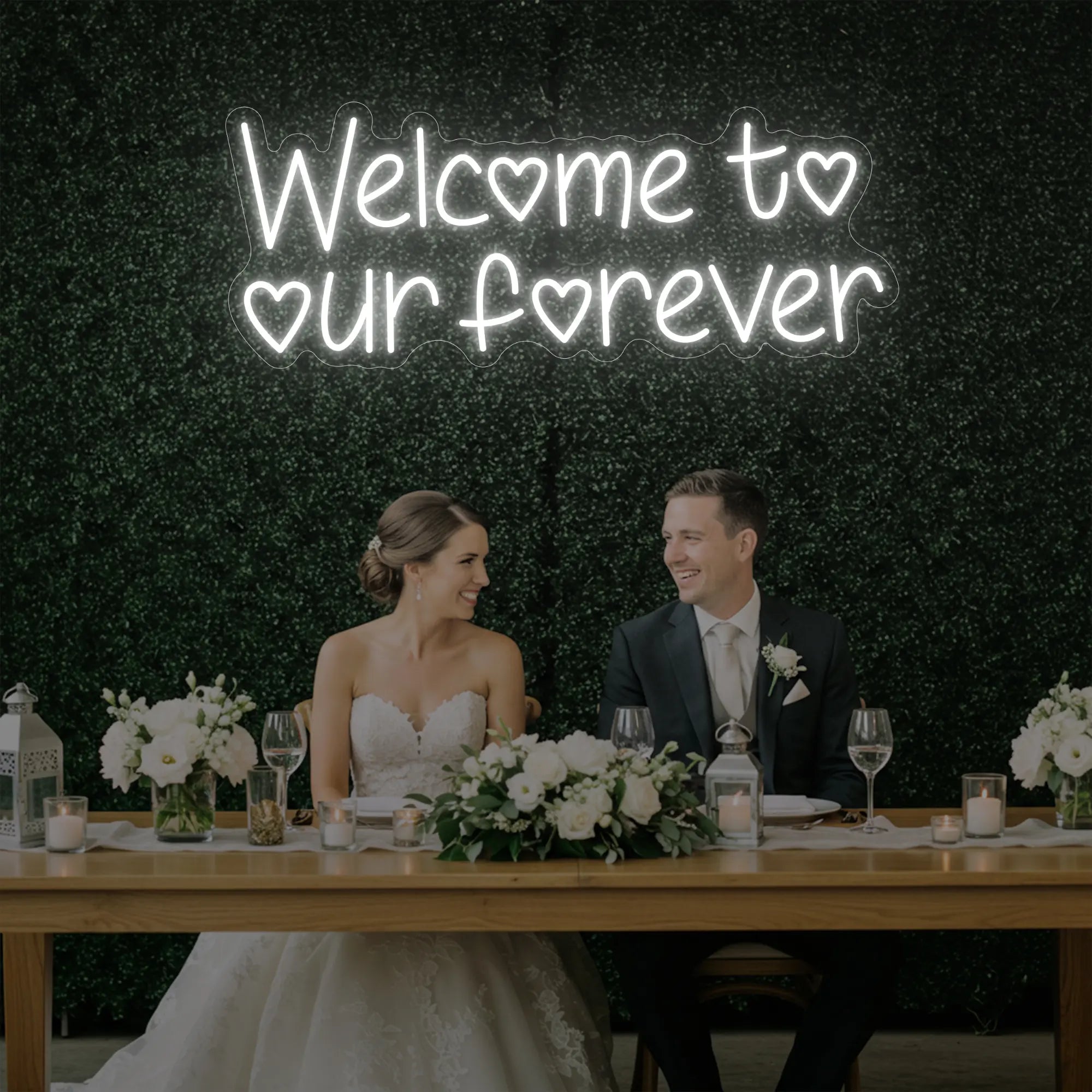 'Welcome To Our Forever' neon sign glowing in cool white against a styled interior wall.