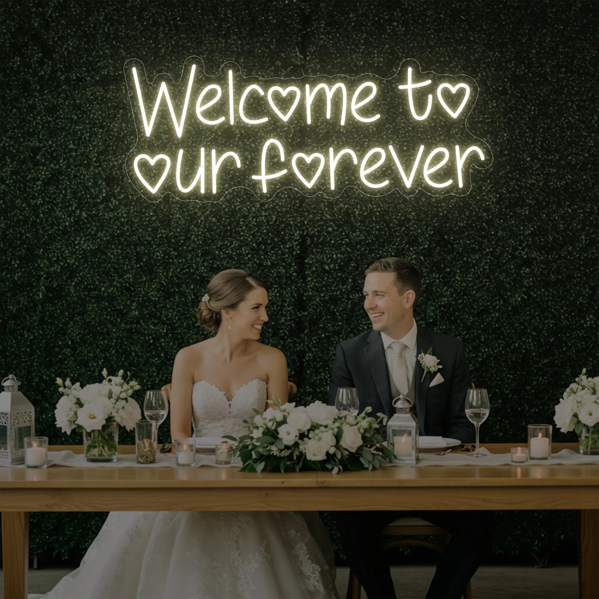 'Welcome To Our Forever' neon sign glowing in warm white against a styled interior wall.