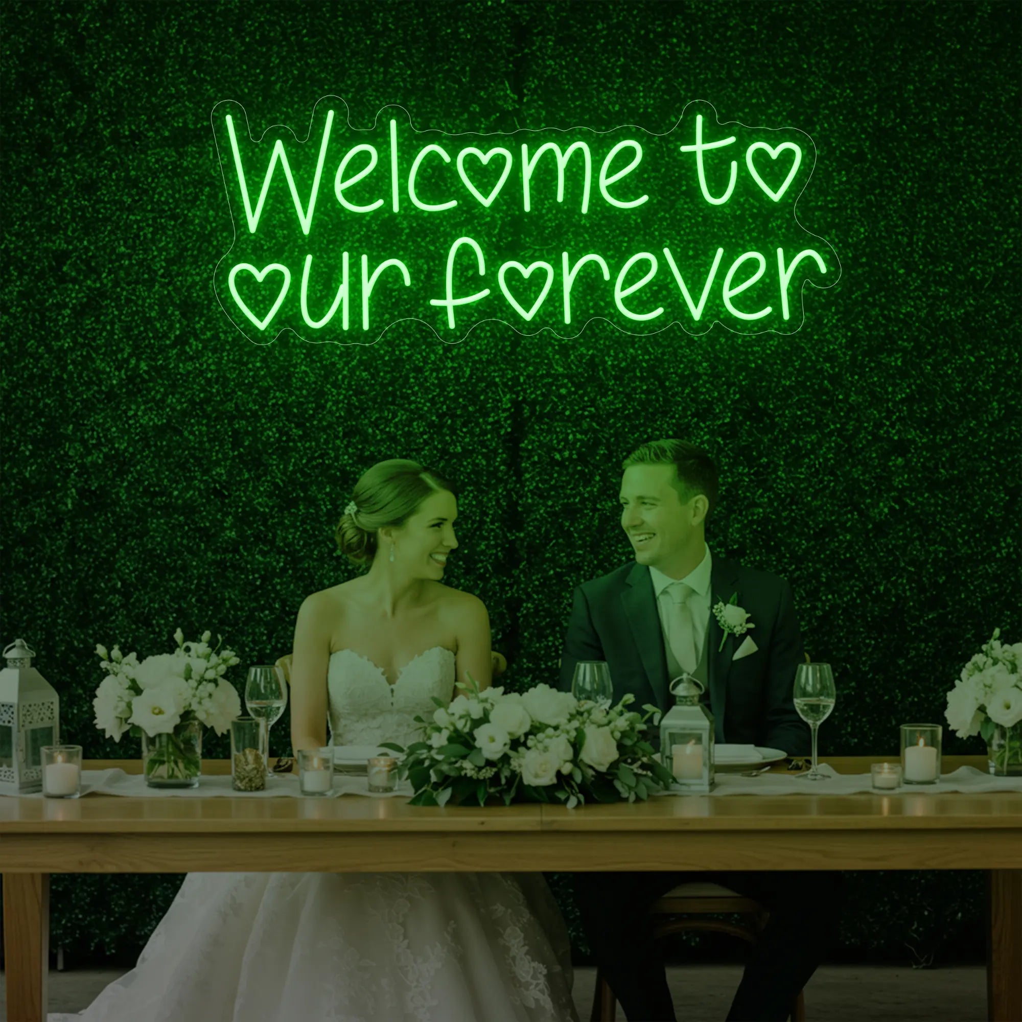 'Welcome To Our Forever' neon sign glowing in green against a styled interior wall.