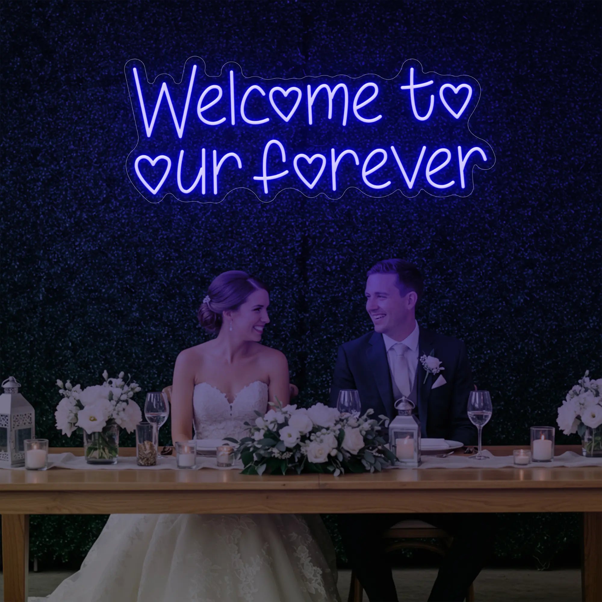 'Welcome To Our Forever' neon sign glowing in deep blue against a styled interior wall.