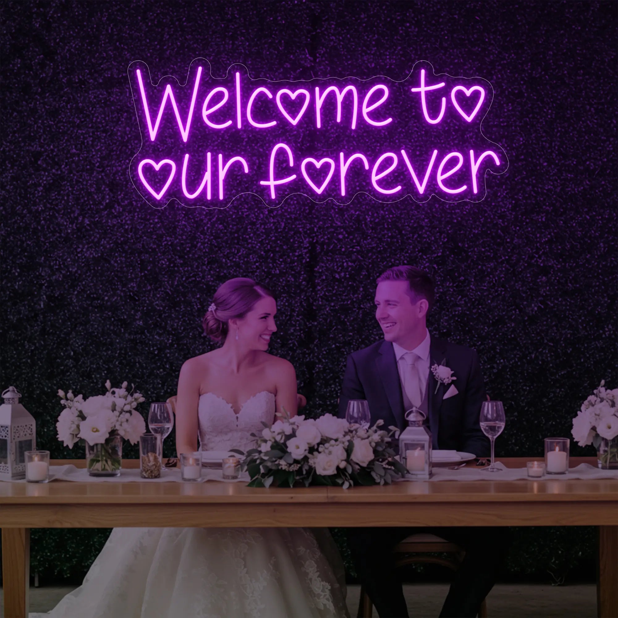 'Welcome To Our Forever' neon sign glowing in deep pink against a styled interior wall.