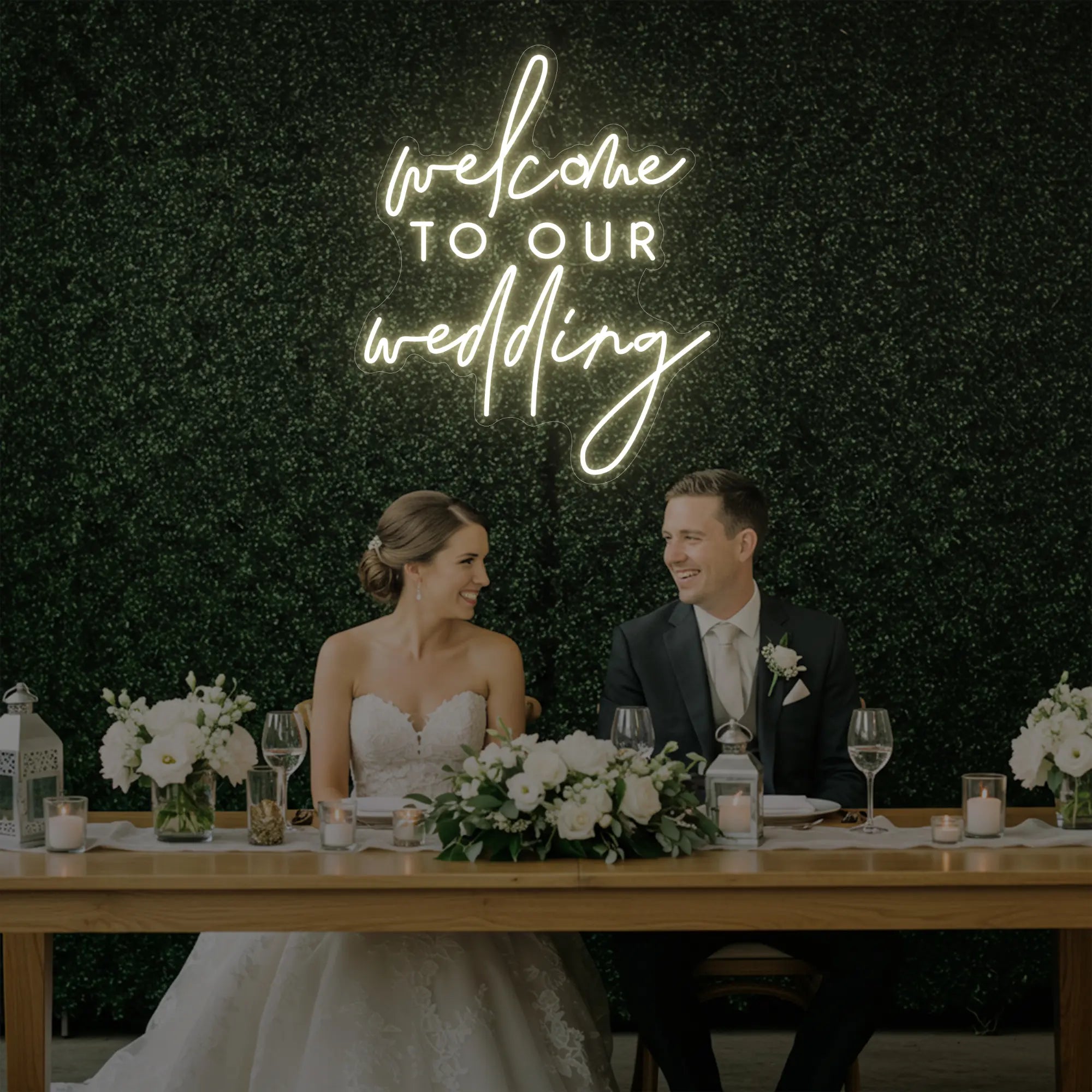 'Welcome To Our Wedding' neon sign glowing in warm white against a styled interior wall.