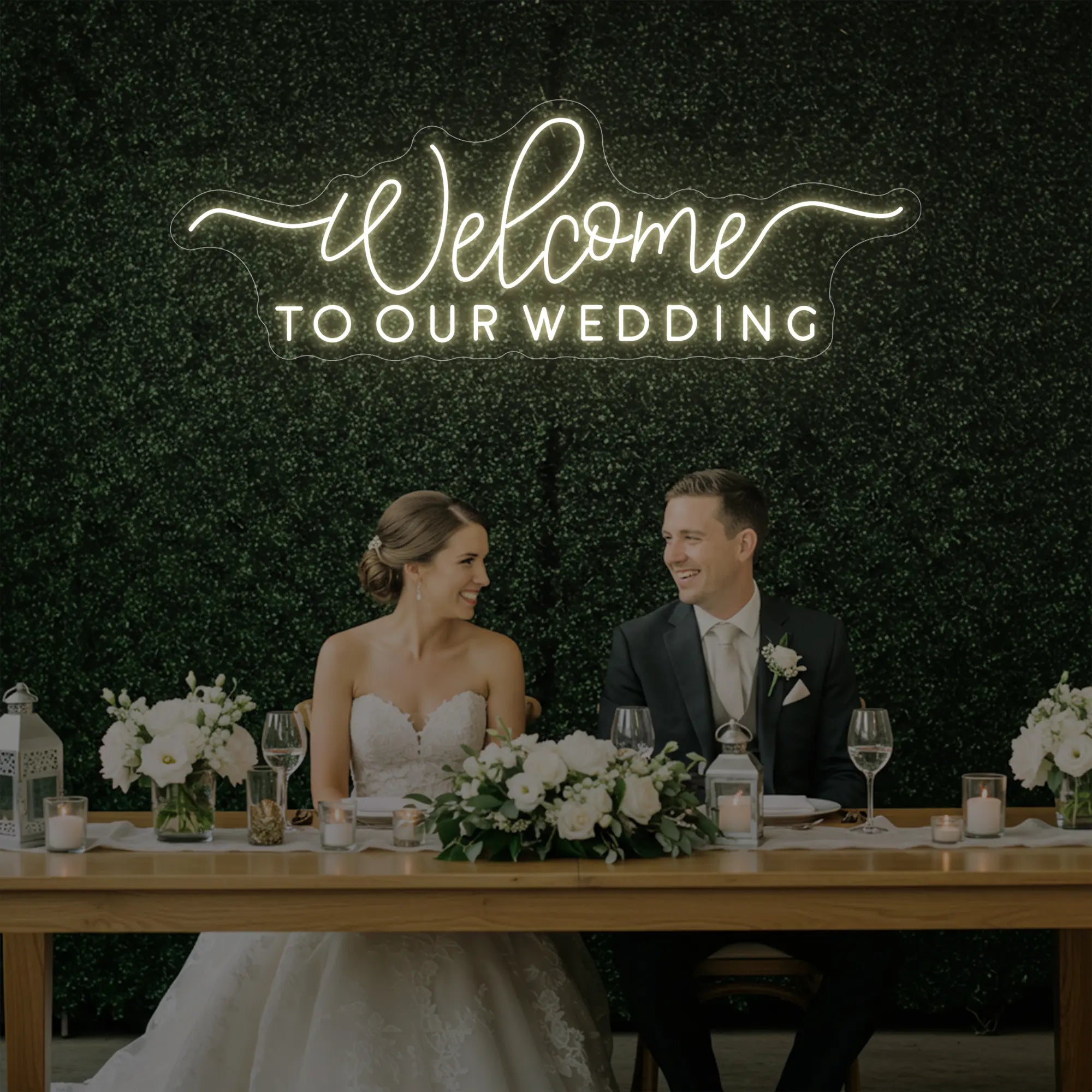 'Welcome To Our Wedding' neon sign glowing in warm white against a styled interior wall.