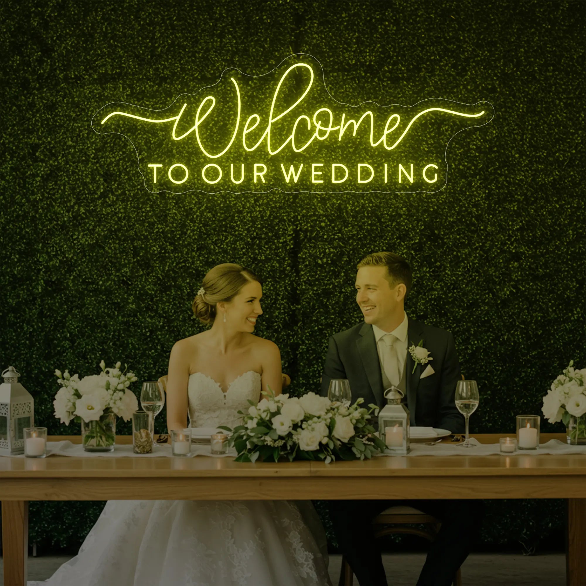 'Welcome To Our Wedding' neon sign glowing in lemon yellow against a styled interior wall.
