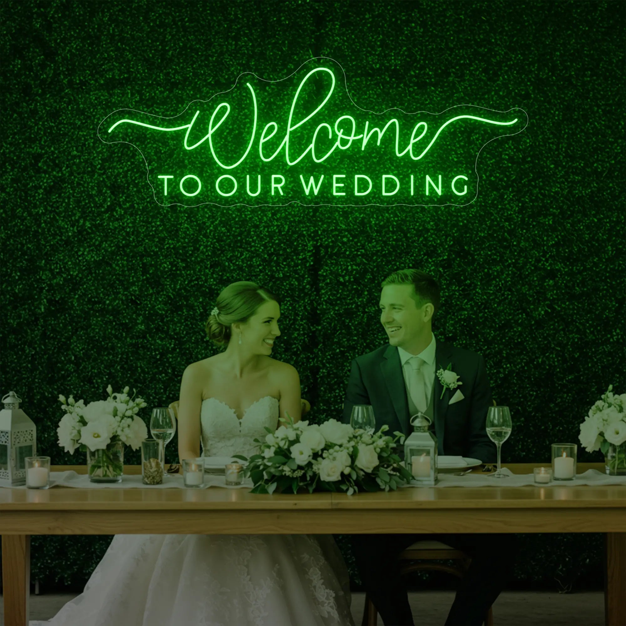 'Welcome To Our Wedding' neon sign glowing in green against a styled interior wall.