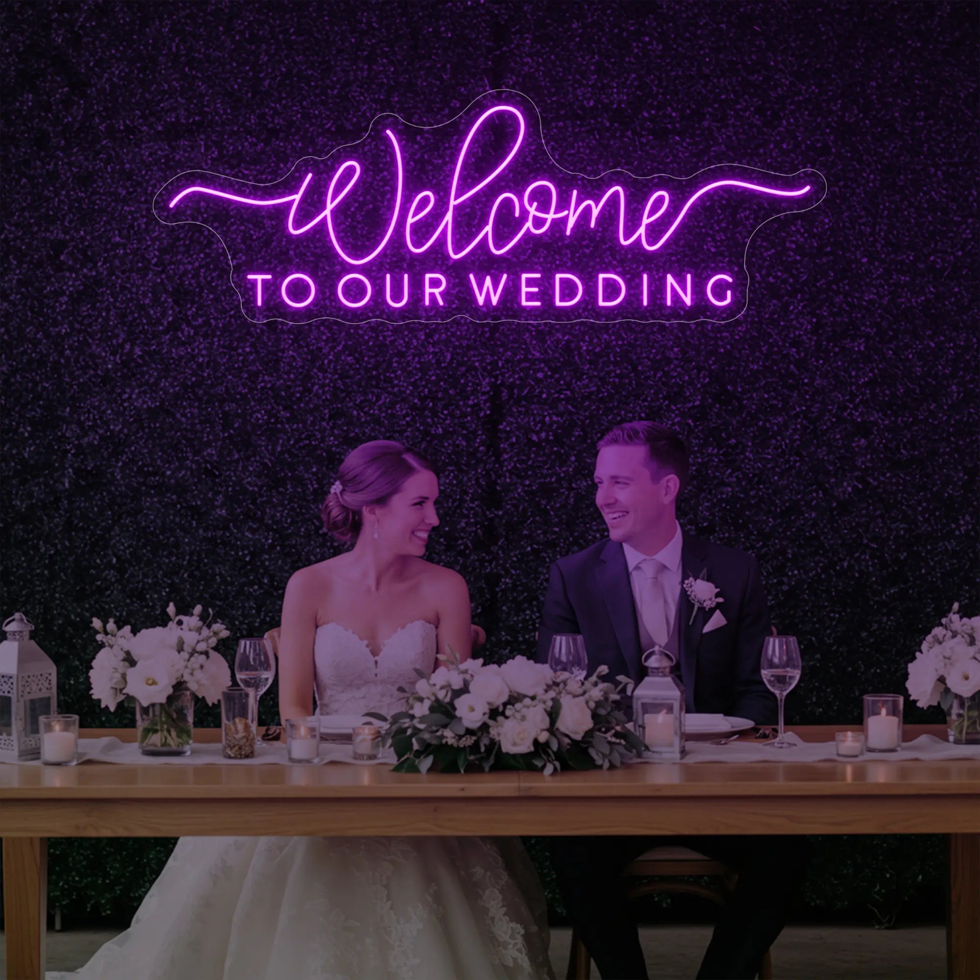 'Welcome To Our Wedding' neon sign glowing in deep pink against a styled interior wall.