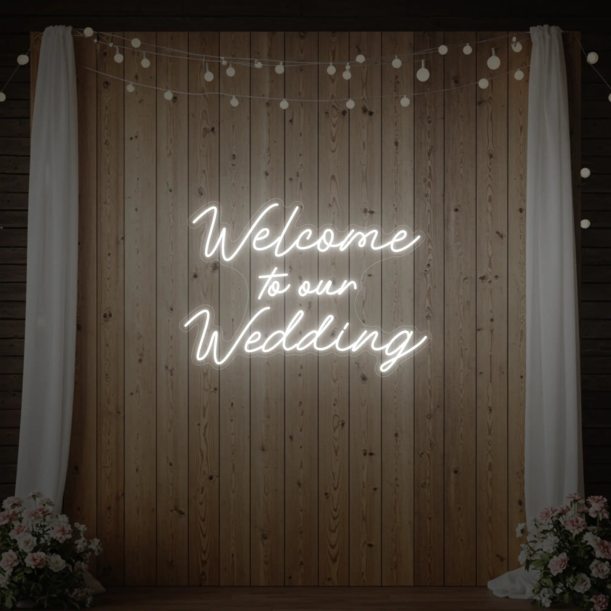 'Welcome To Our Wedding' neon sign glowing in cool white against a styled interior wall.