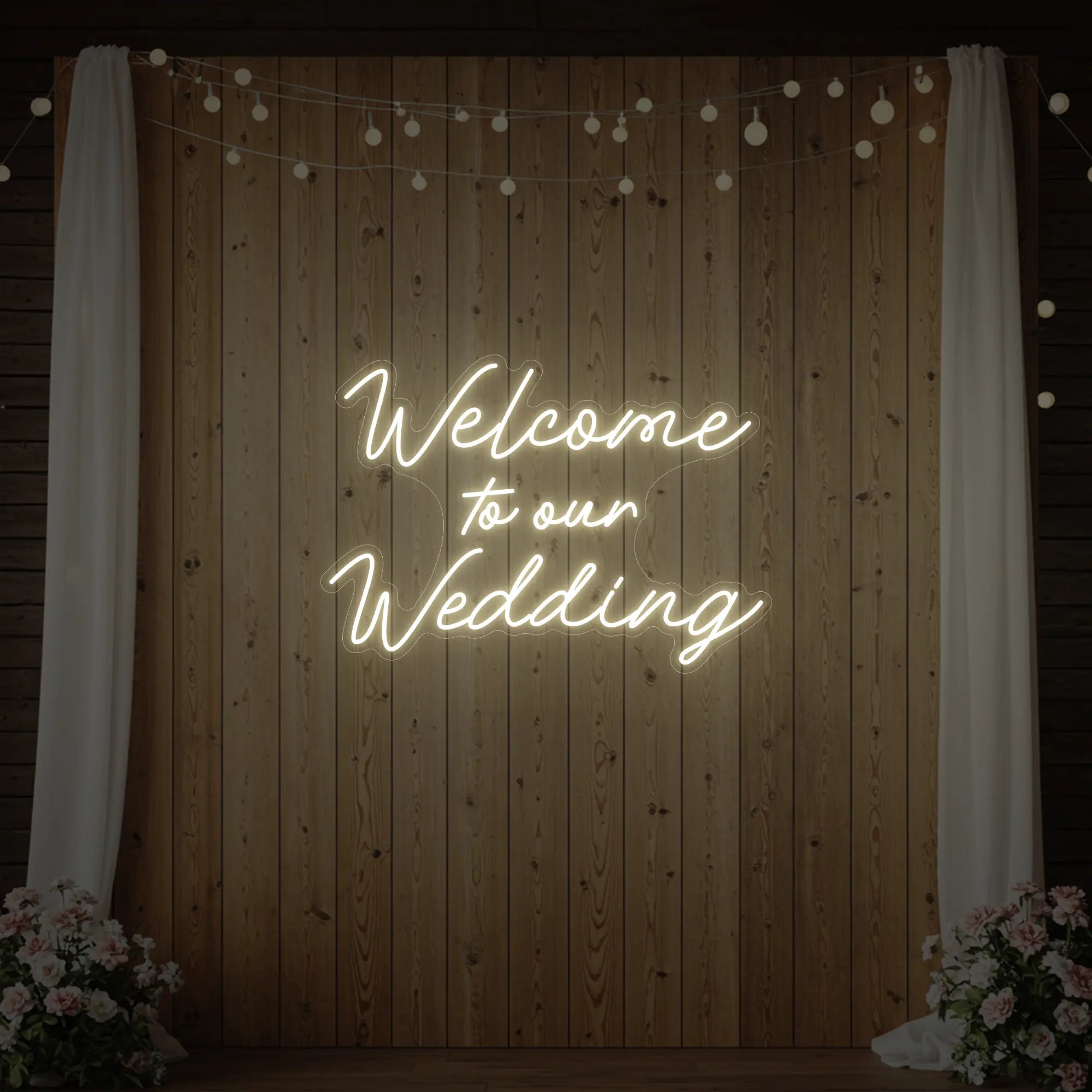 'Welcome To Our Wedding' neon sign glowing in warm white against a styled interior wall.
