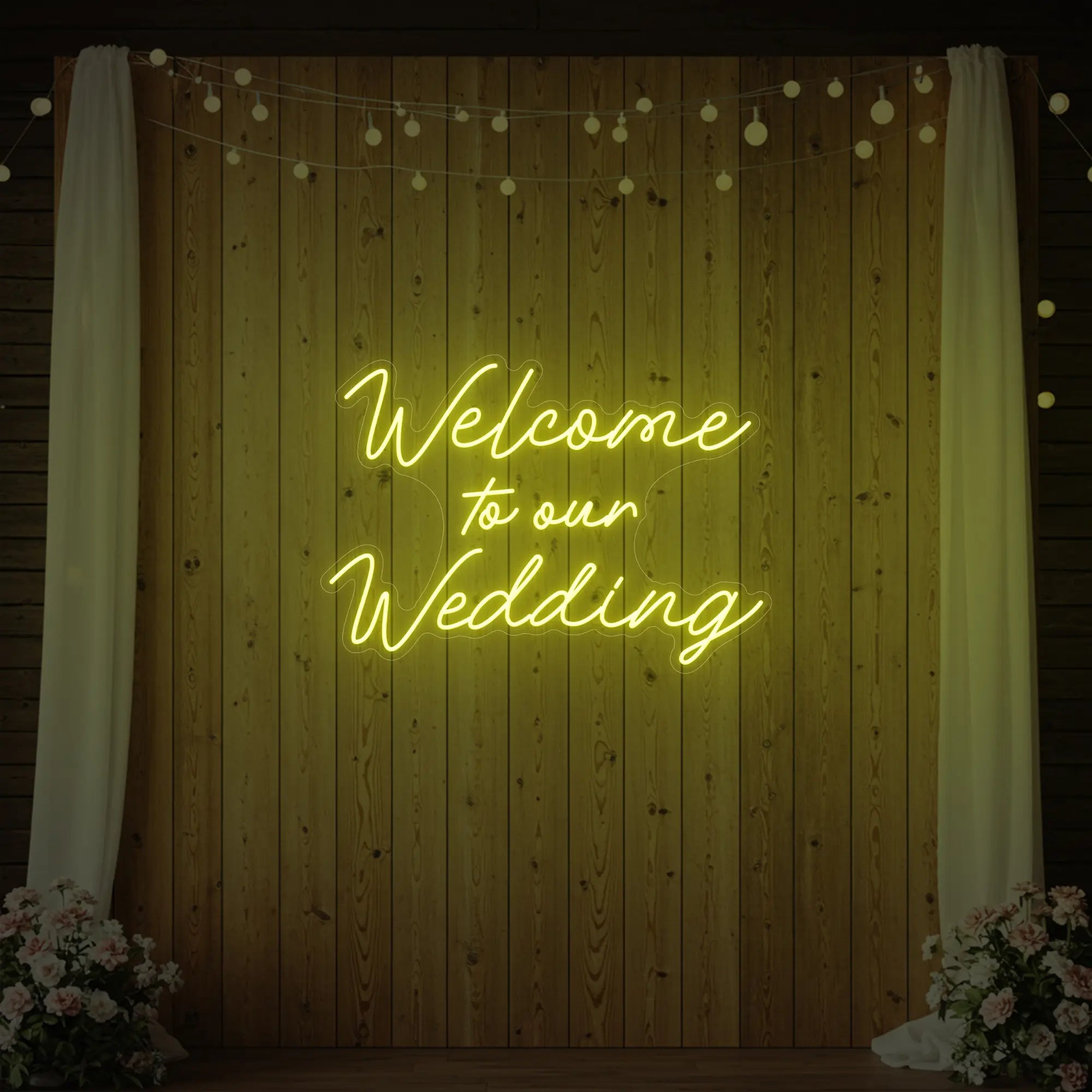 'Welcome To Our Wedding' neon sign glowing in lemon yellow against a styled interior wall.