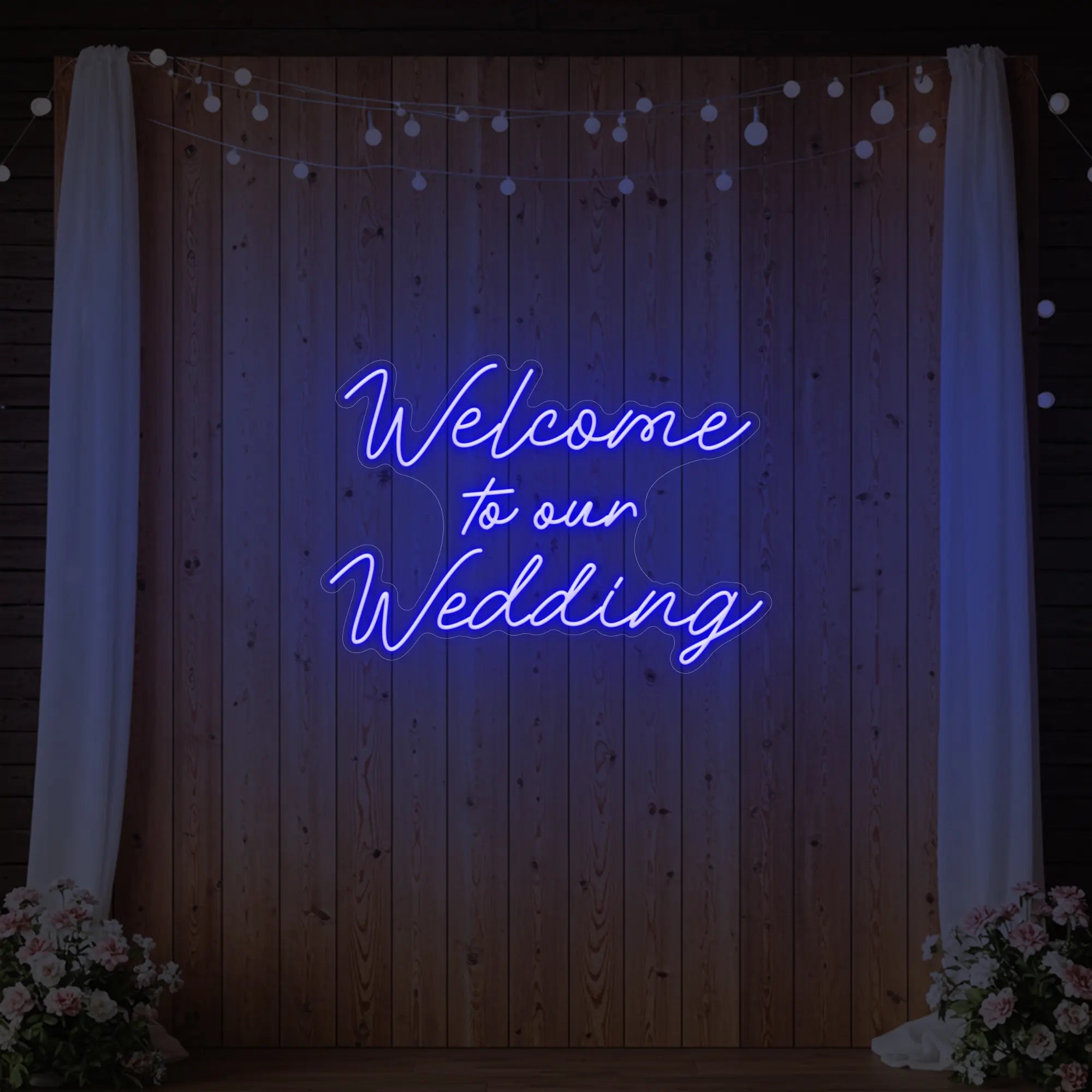 'Welcome To Our Wedding' neon sign glowing in deep blue against a styled interior wall.