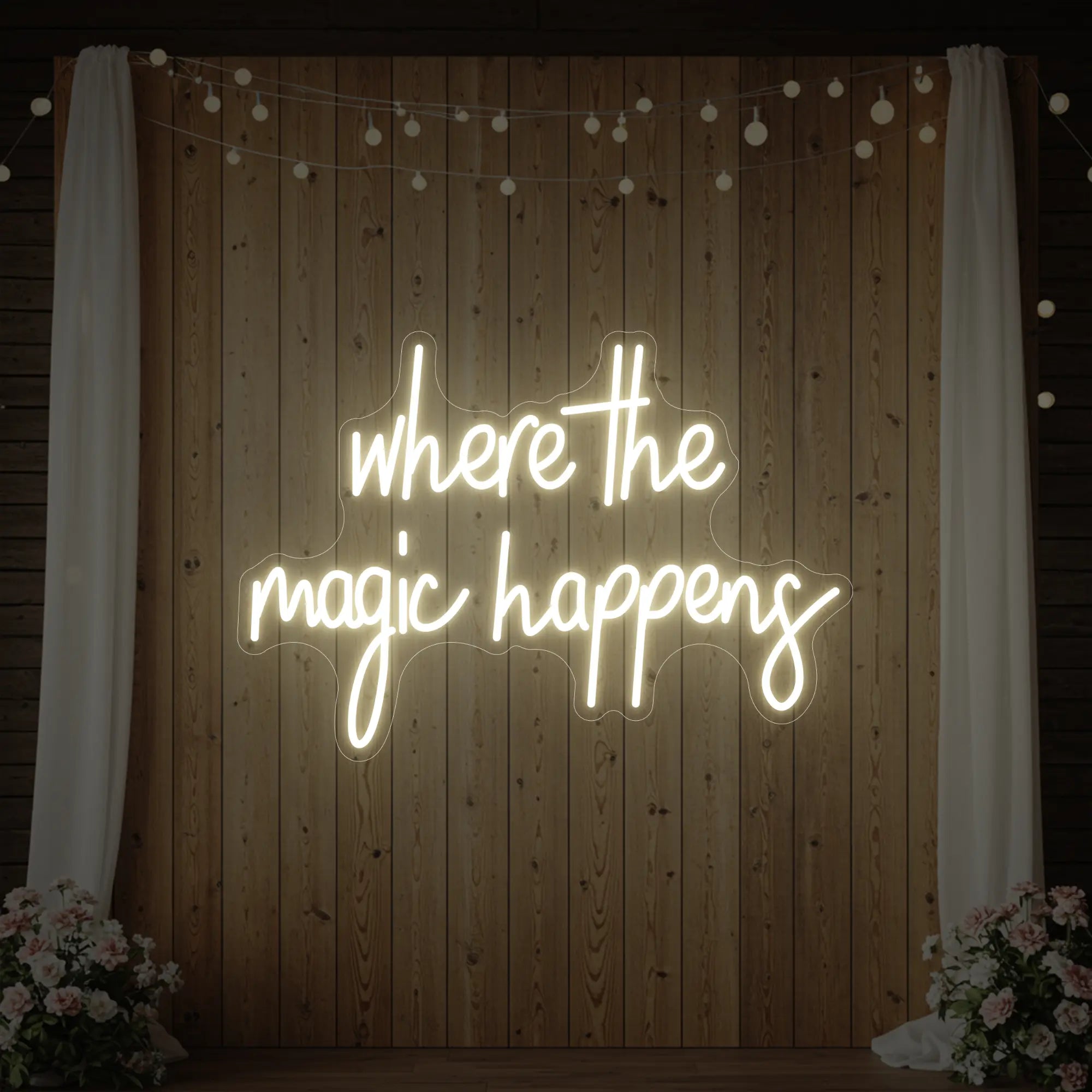 'Where The Magic Happens' neon sign glowing in warm white against a styled interior wall.