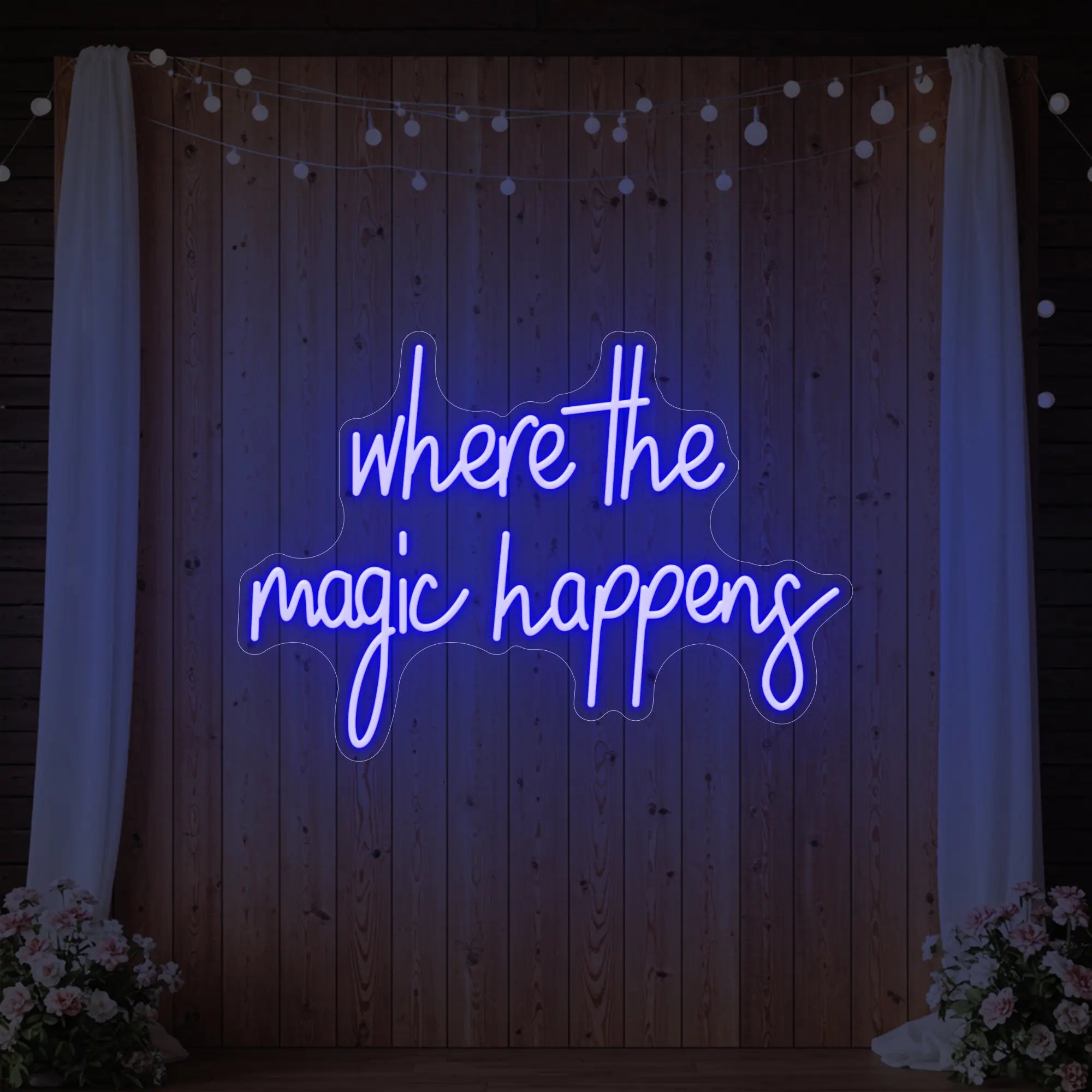 'Where The Magic Happens' neon sign glowing in deep blue against a styled interior wall.