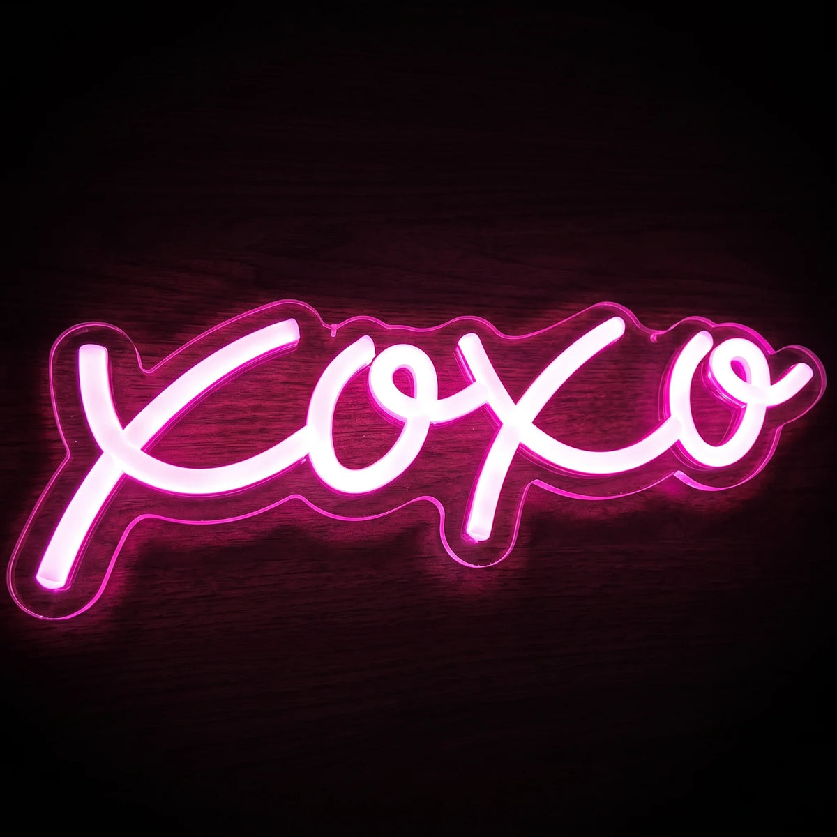 XOXO LED Neon Sign featuring bright pink handwritten-style lettering on a clear acrylic backing.