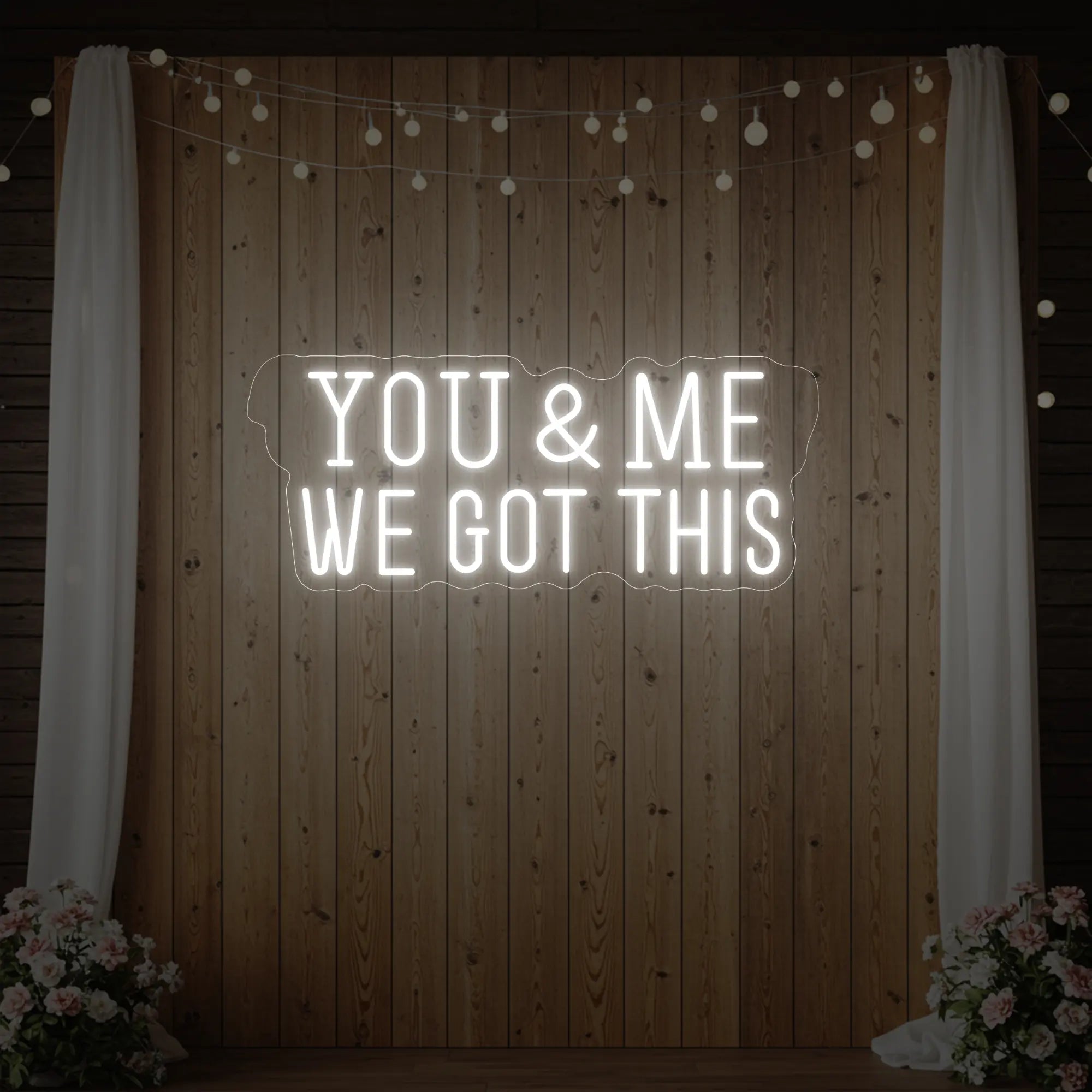 'You & Me We Got This' neon sign glowing in cool white against a styled interior wall.
