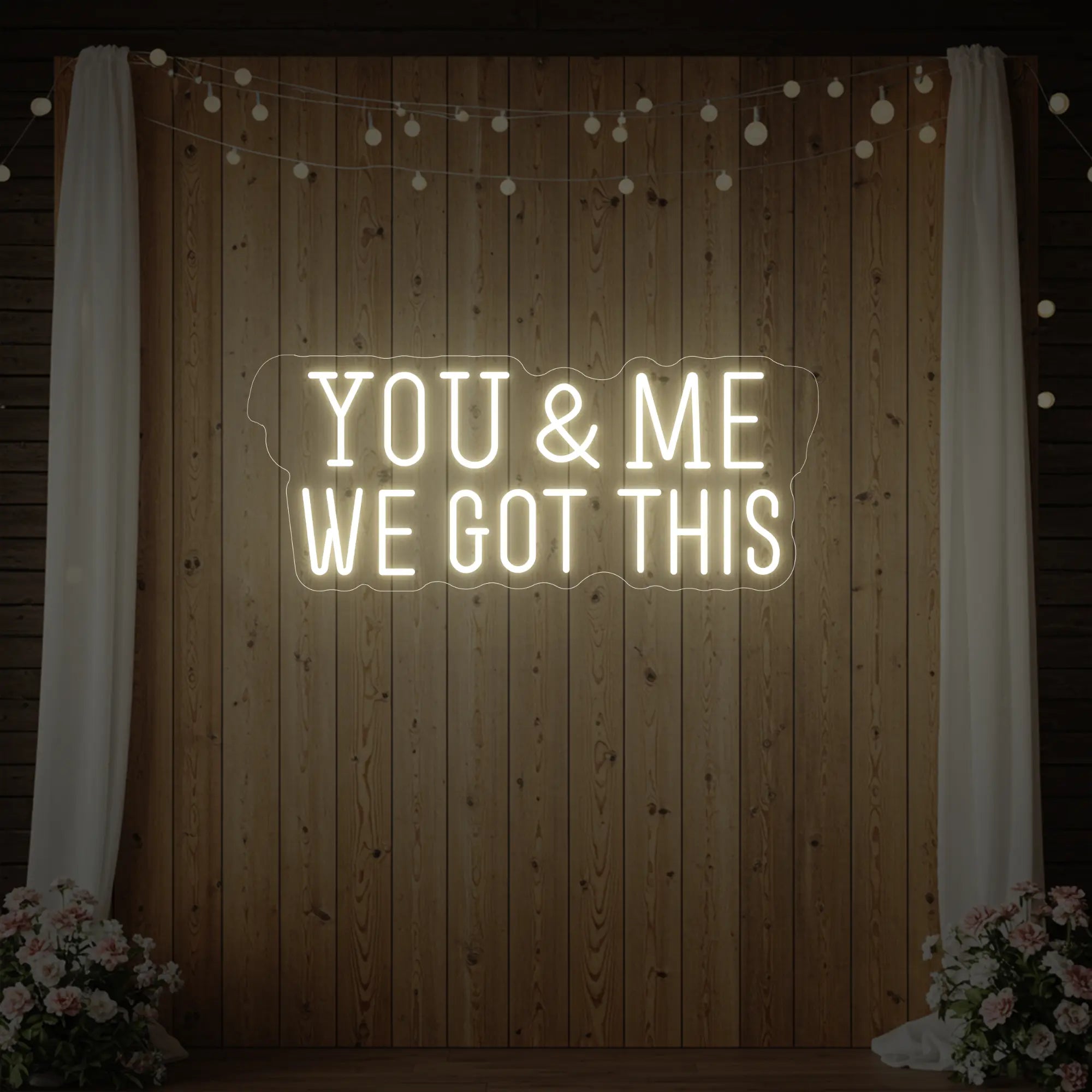 'You & Me We Got This' neon sign glowing in warm white against a styled interior wall.
