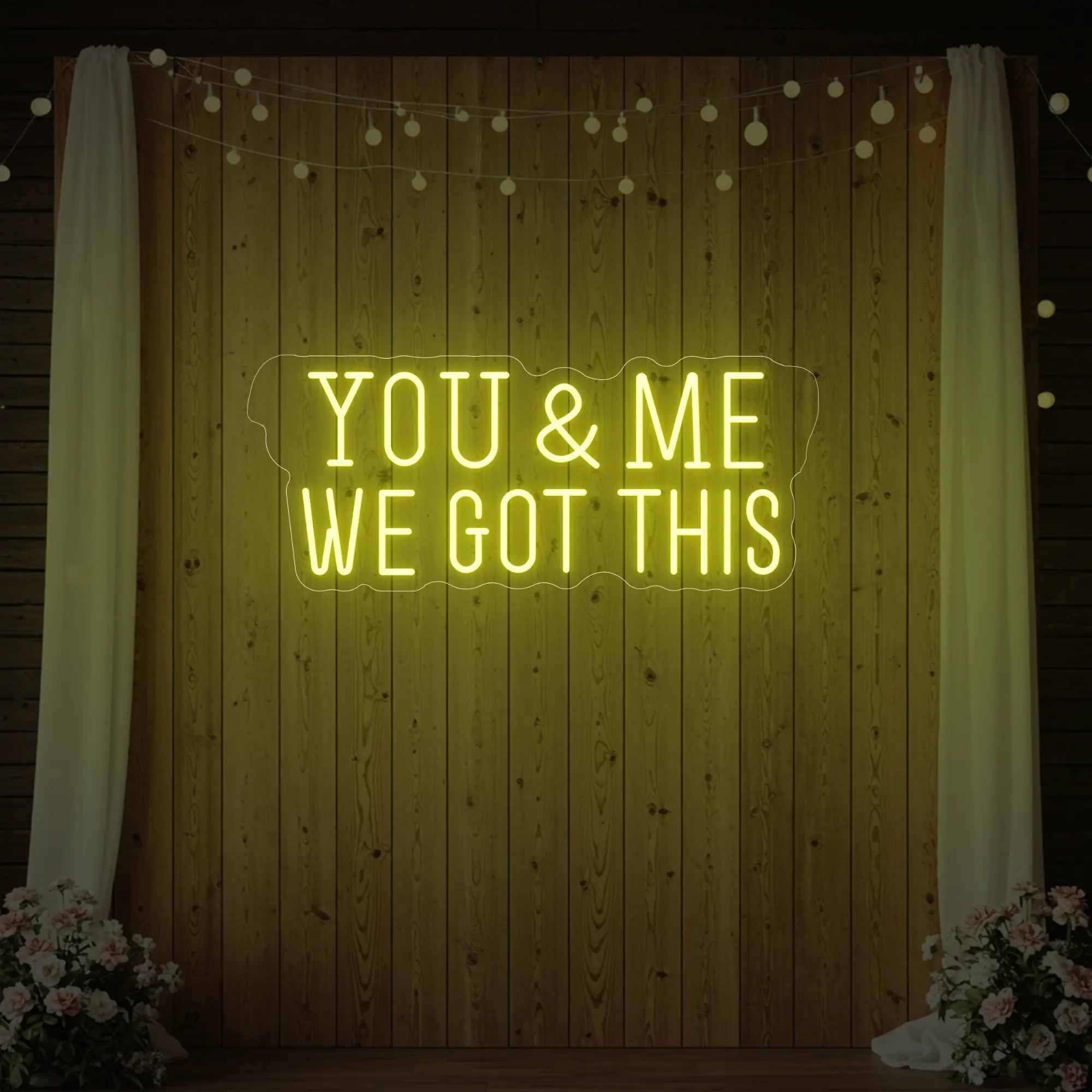 'You & Me We Got This' neon sign glowing in lemon yellow against a styled interior wall.