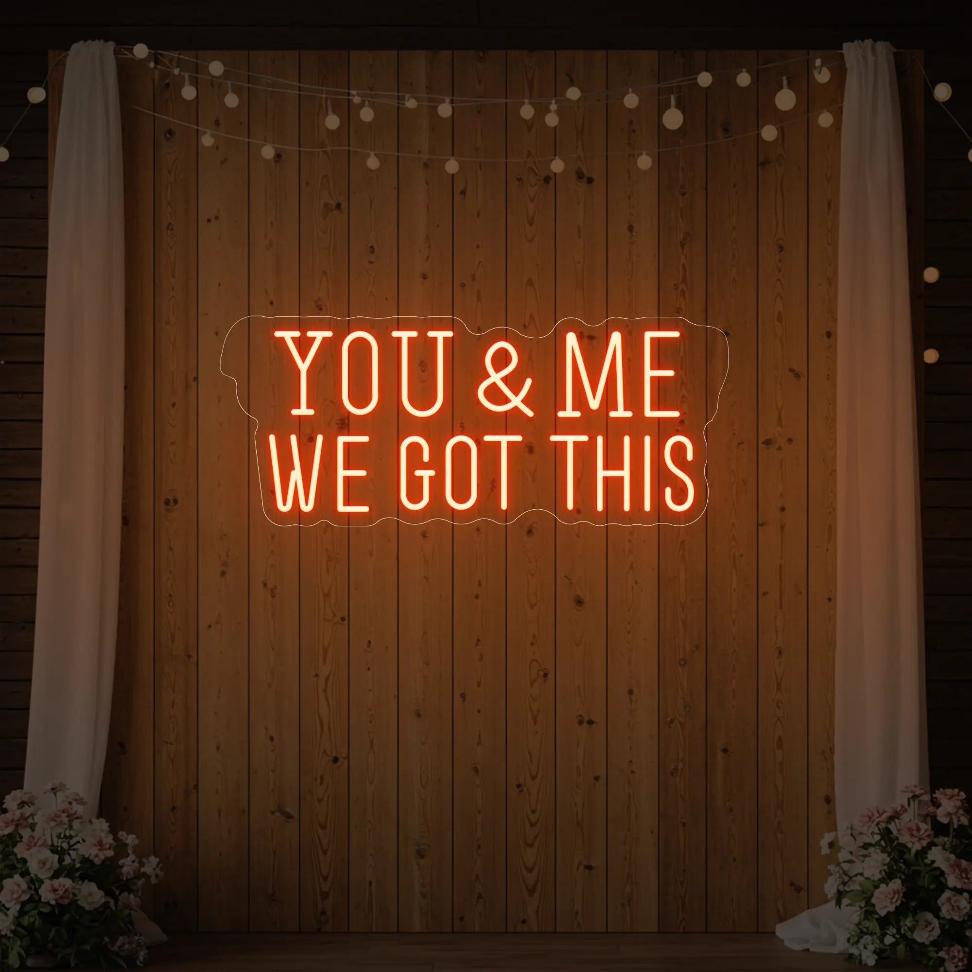 'You & Me We Got This' neon sign glowing in golden yellow against a styled interior wall.
