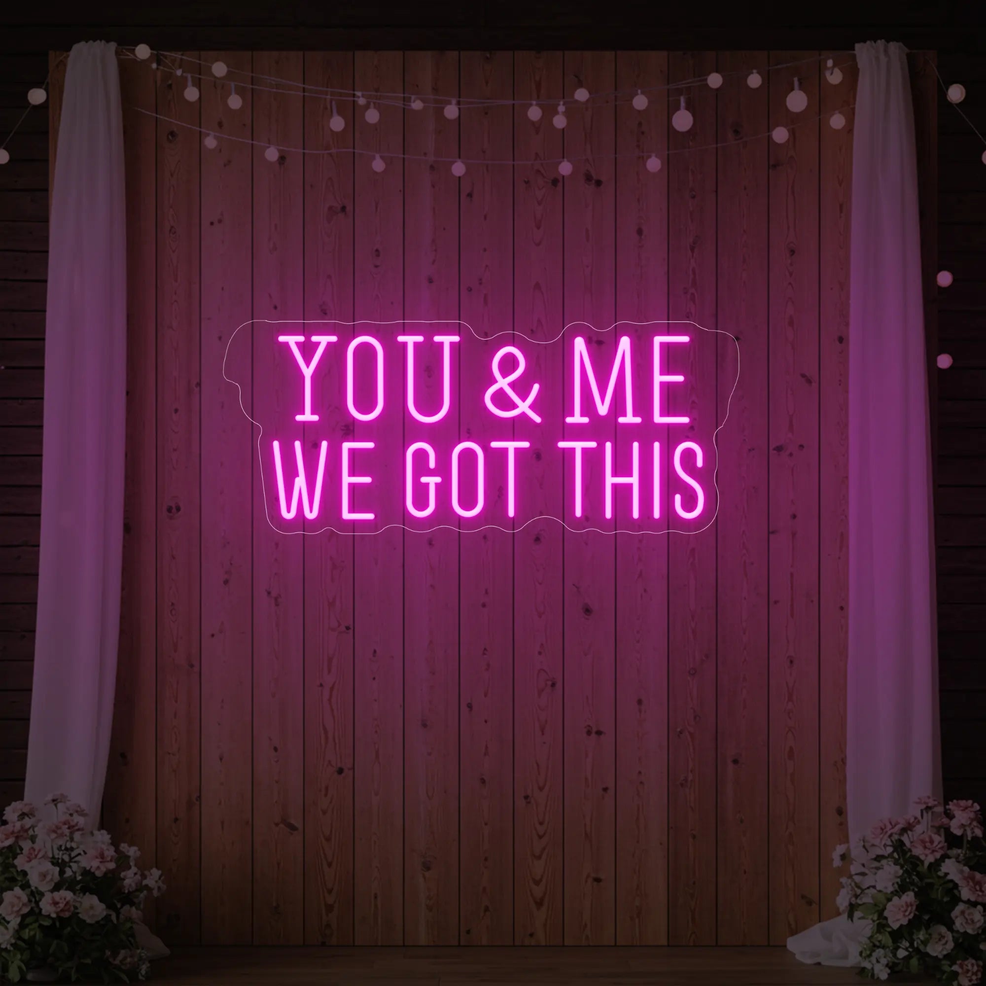 'You & Me We Got This' neon sign glowing in light pink against a styled interior wall.