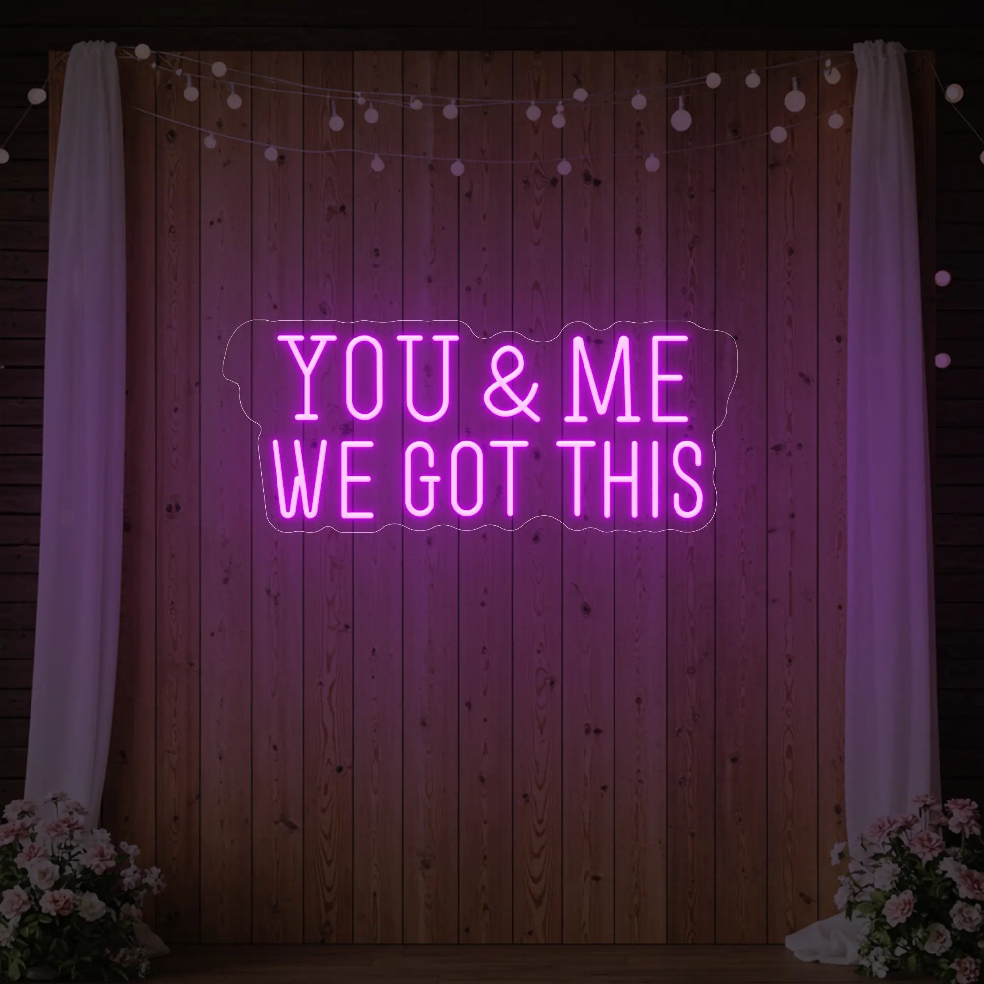 'You & Me We Got This' neon sign glowing in deep pink against a styled interior wall.