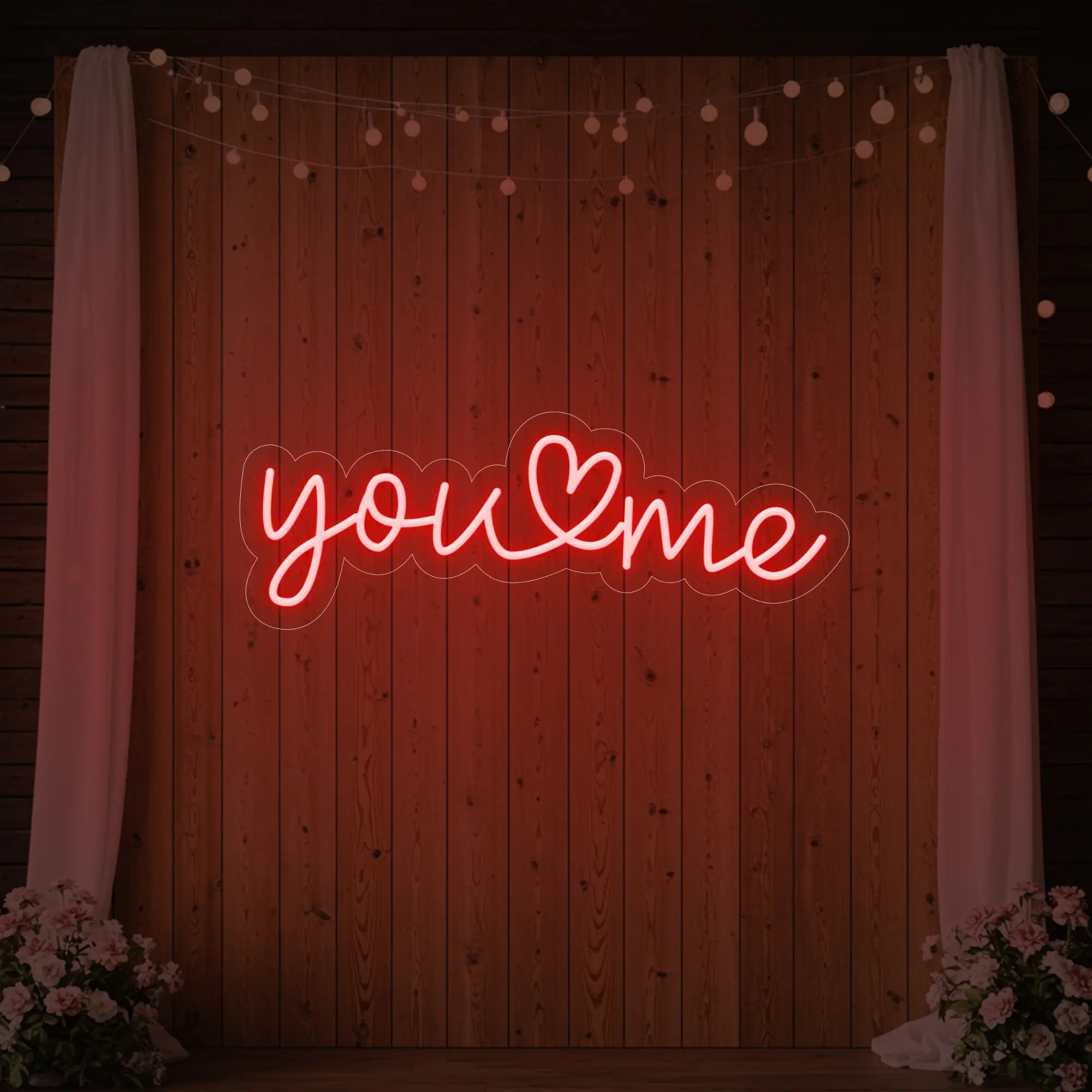 'You Heart Me' neon sign glowing in red against a styled interior wall.
