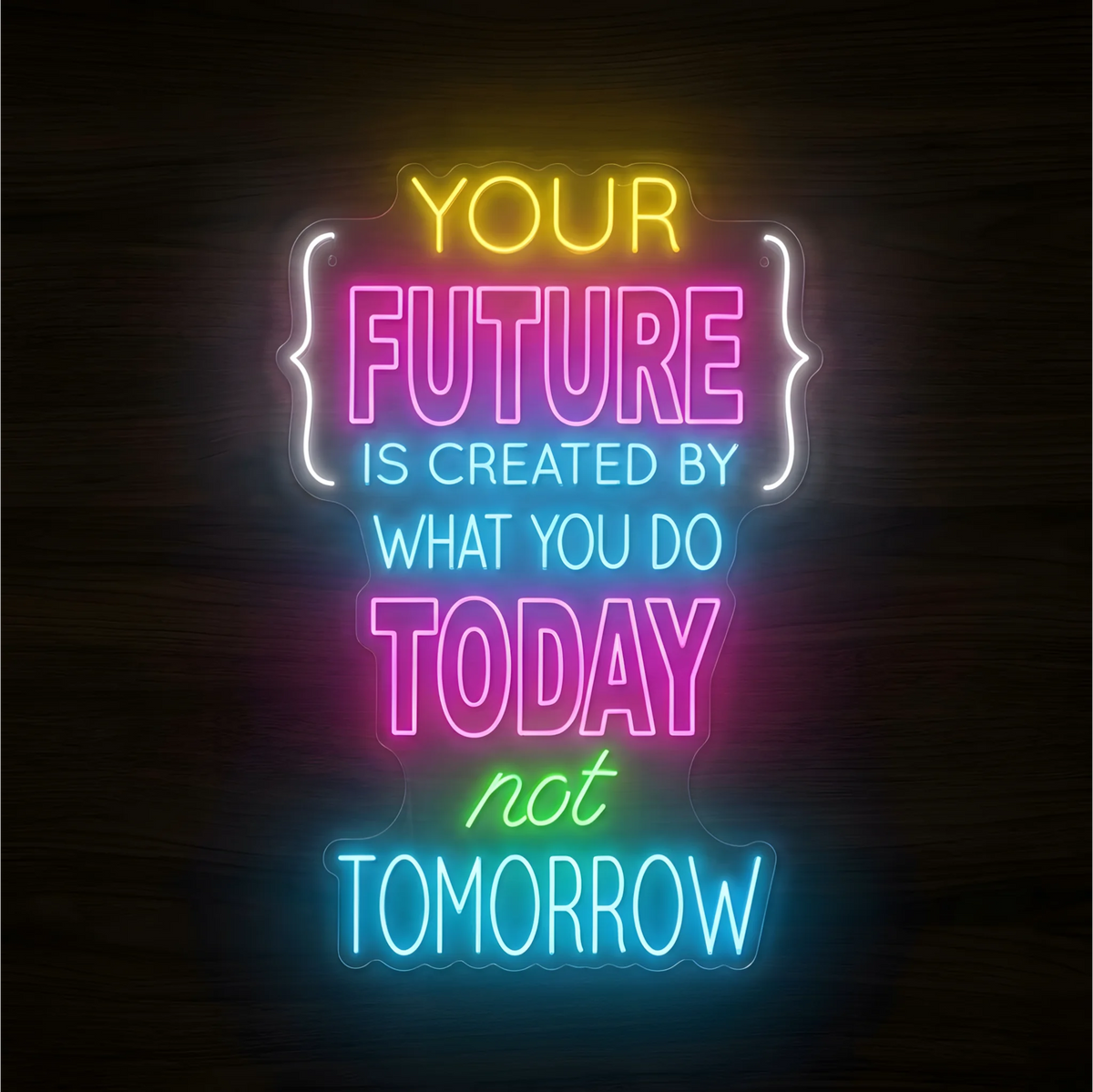 “YOUR FUTURE IS CREATED BY WHAT YOU DO TODAY not TOMORROW” LED Neon Sign with yellow, pink, cyan, green, and white lettering, white bracket-like accents, and clear acrylic backing against a dark wood background, suited to office and gym decor.