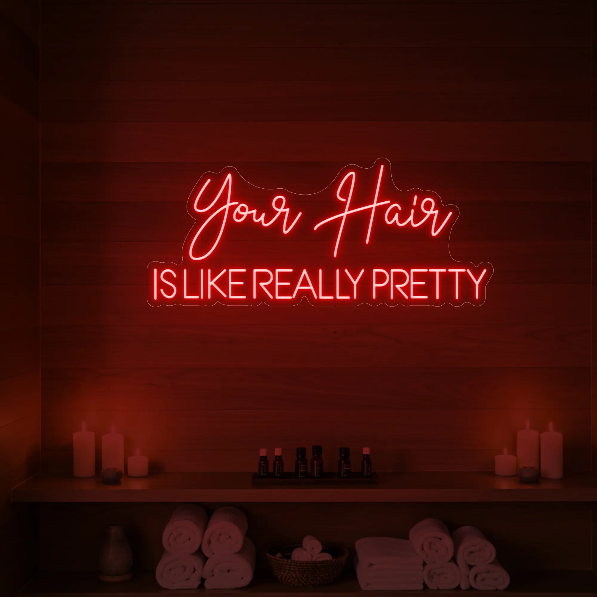 Photo of the 'Your Hair Is Like Really Pretty' neon sign glowing in red against a styled interior wall.
