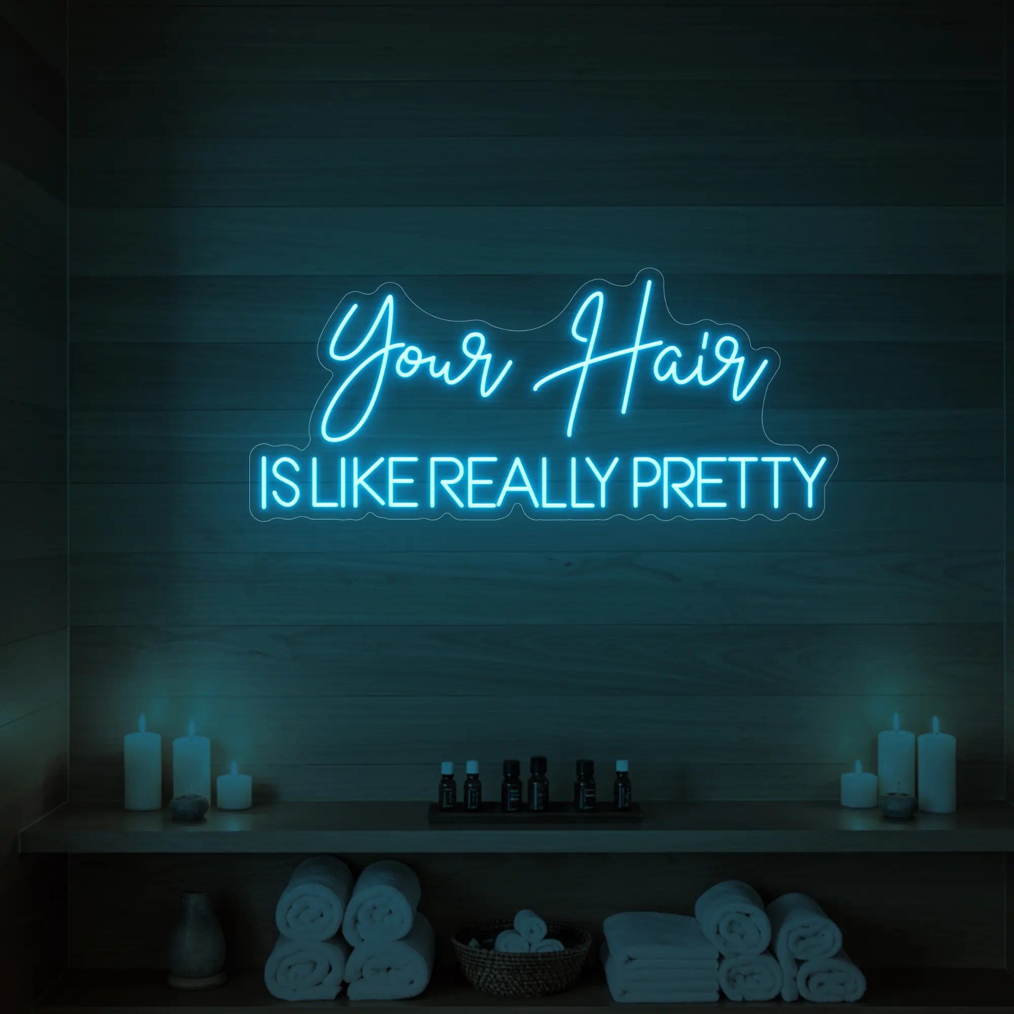 Photo of the 'Your Hair Is Like Really Pretty' neon sign glowing in ice blue against a styled interior wall.