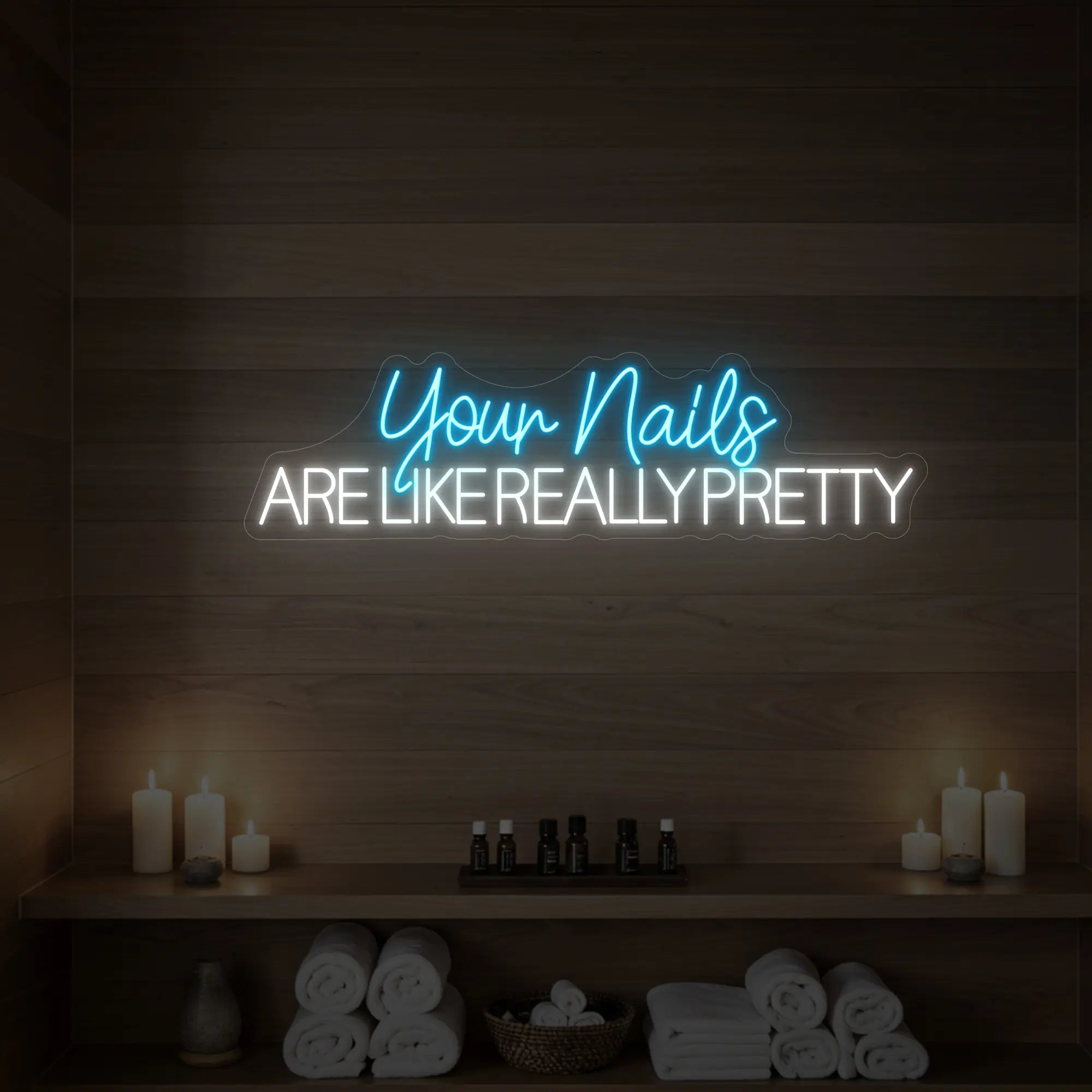 Photo of the 'Your Nails Are Like Really Pretty' neon sign glowing in ice blue against a styled interior wall.