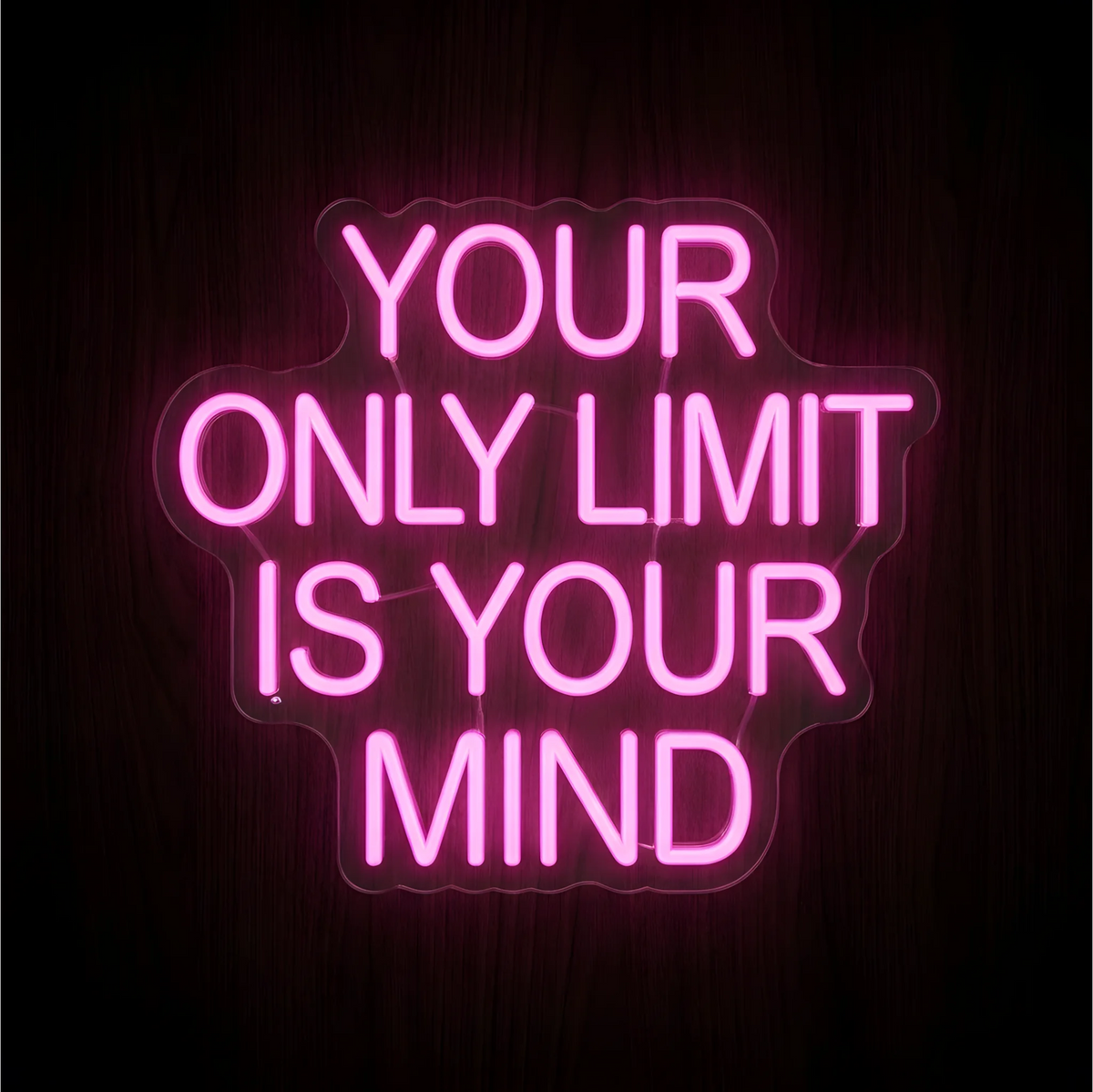 Your Only Limit Is Your Mind LED Neon Sign displaying “YOUR ONLY LIMIT IS YOUR MIND” in bright pink uppercase lettering across four centered lines on contoured clear acrylic backing against a dark wood background, ideal for home office and gym motivational wall decor.