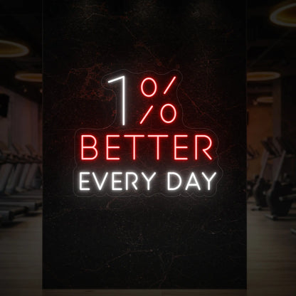 '1% Better Every Day' neon sign glowing in red and cool white against a styled interior wall.