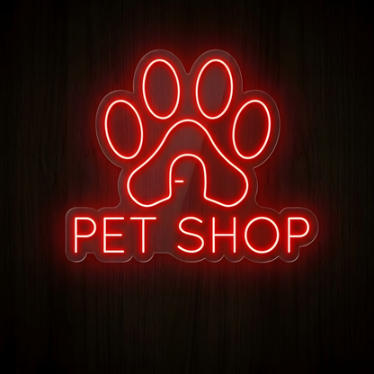 Paw House Pet Shop LED Neon Sign featuring a bright red glowing paw print with a house-shaped center and illuminated PET SHOP lettering on clear acrylic backing, designed for pet stores, pet supply shops, pet boutiques, animal care businesses, and pet retail storefronts