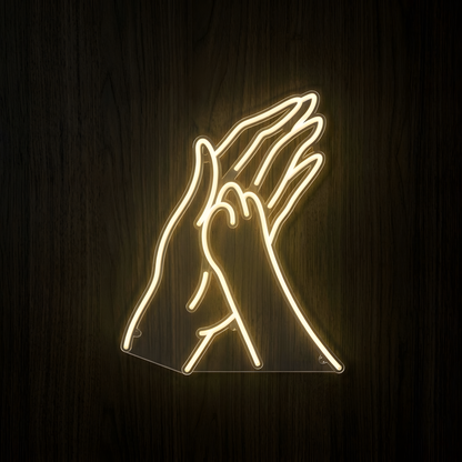 Pet High Five LED Neon Sign featuring warm white line art of a human hand giving a dog paw a high five, mounted on clear acrylic against a dark wood wall for pet store, veterinary clinic, grooming salon, or animal lover decor.