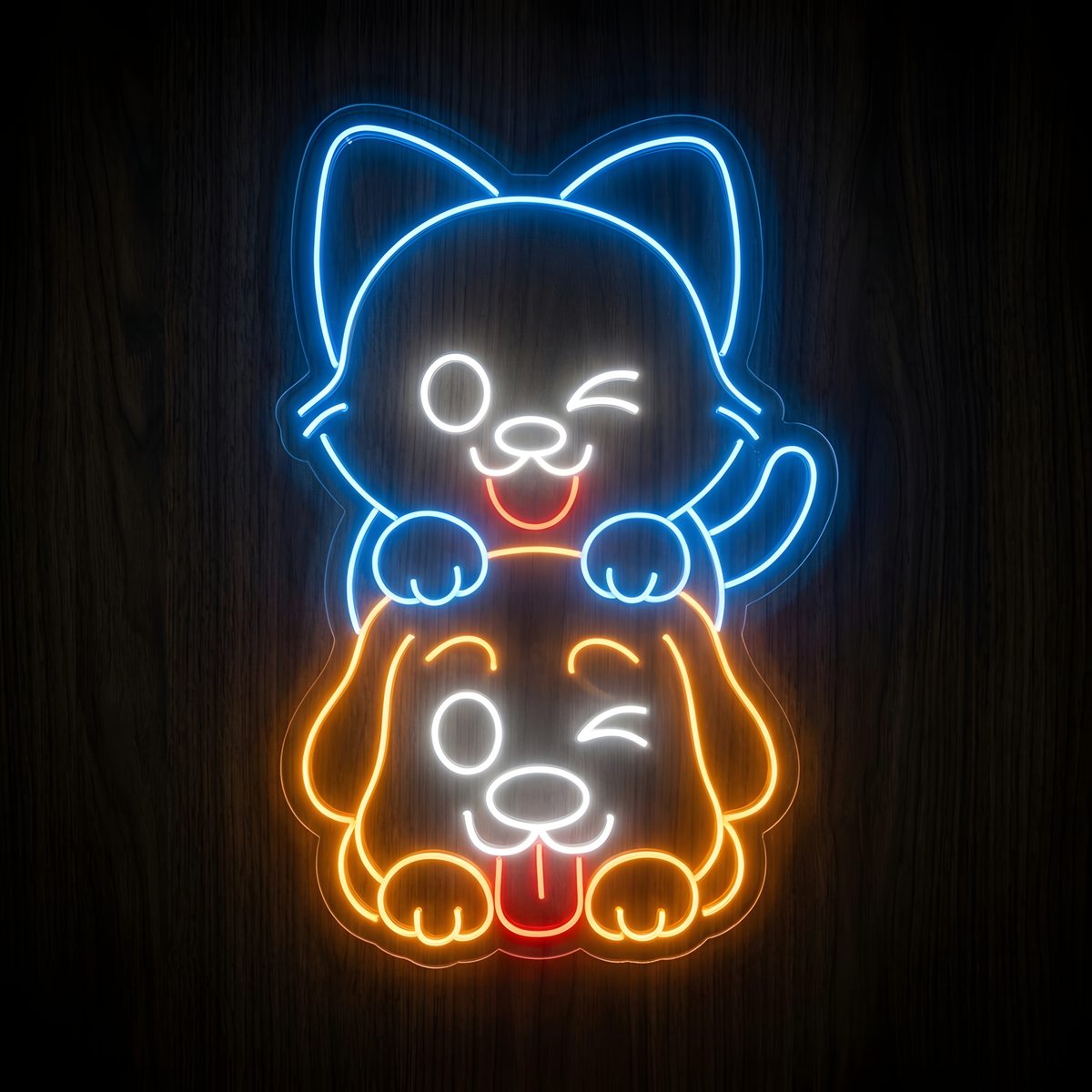Playful Cat and Dog LED Neon Sign featuring a bright blue smiling cat sitting on an orange dog with white facial details and red tongue accents, displayed on clear acrylic against a dark wood wall for pet store, veterinary clinic, grooming salon, or animal lover decor.