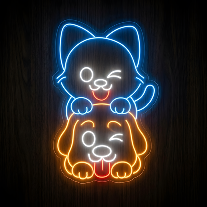 Playful Cat and Dog LED Neon Sign featuring a bright blue smiling cat sitting on an orange dog with white facial details and red tongue accents, displayed on clear acrylic against a dark wood wall for pet store, veterinary clinic, grooming salon, or animal lover decor.