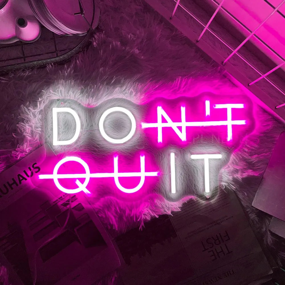 Pink "DON'T QUIT" neon sign