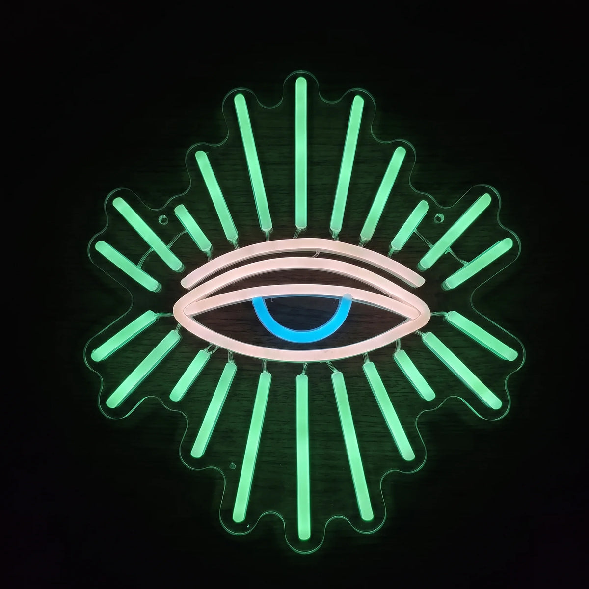 All Seeing Eye LED Neon Sign featuring a glowing eye with green radiant beams, soft pink outlines, and a blue center.