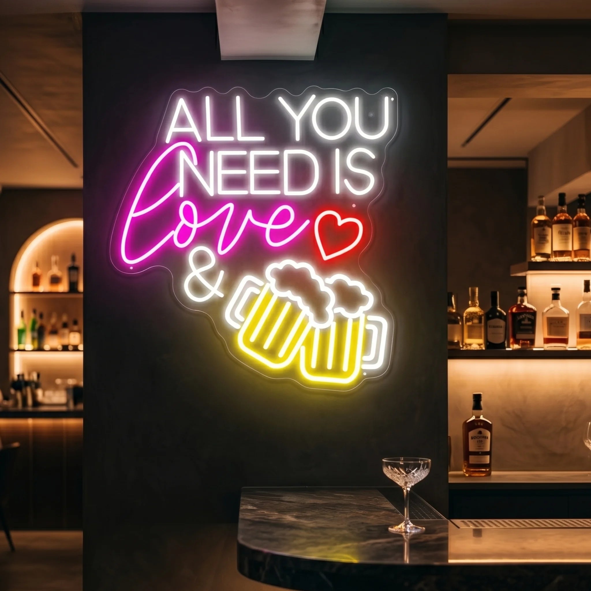 Photo of the 'ALL YOU NEED IS LOVE & BEER' neon sign glowing in cool white against a styled interior wall.