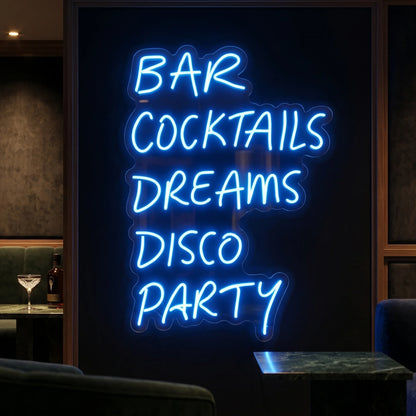 Photo of the 'BAR COCKTAILS DREAMS DISCO PARTY' neon sign glowing in deep blue against a styled interior wall.