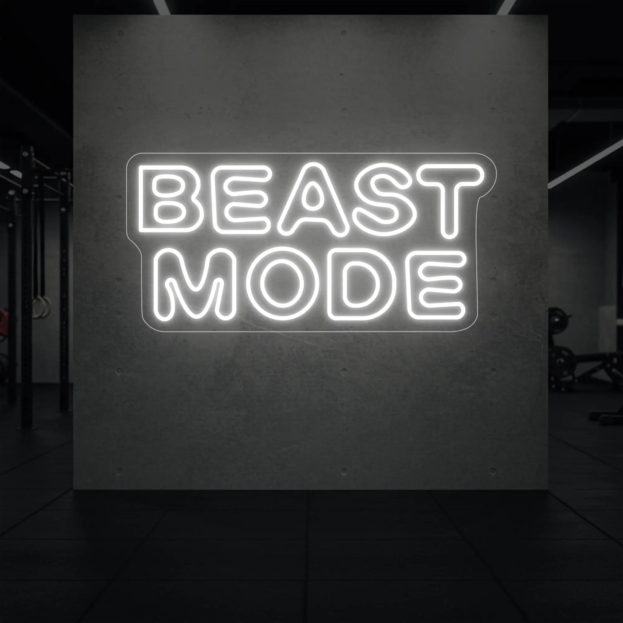 'Beast Mode' neon sign glowing in cool white against a styled interior wall.