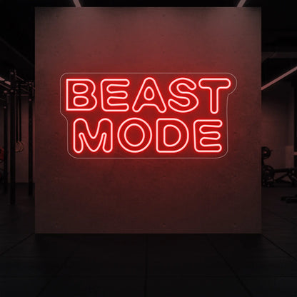 'Beast Mode' neon sign glowing in red against a styled interior wall.
