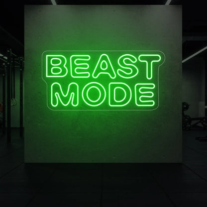 'Beast Mode' neon sign glowing in green against a styled interior wall.