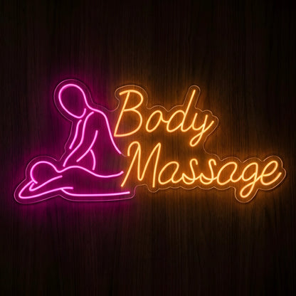Body Massage Spa LED Neon Sign featuring a pink outline of a massage therapist and reclining client with warm orange cursive lettering on clear acrylic against a dark wooden wall.