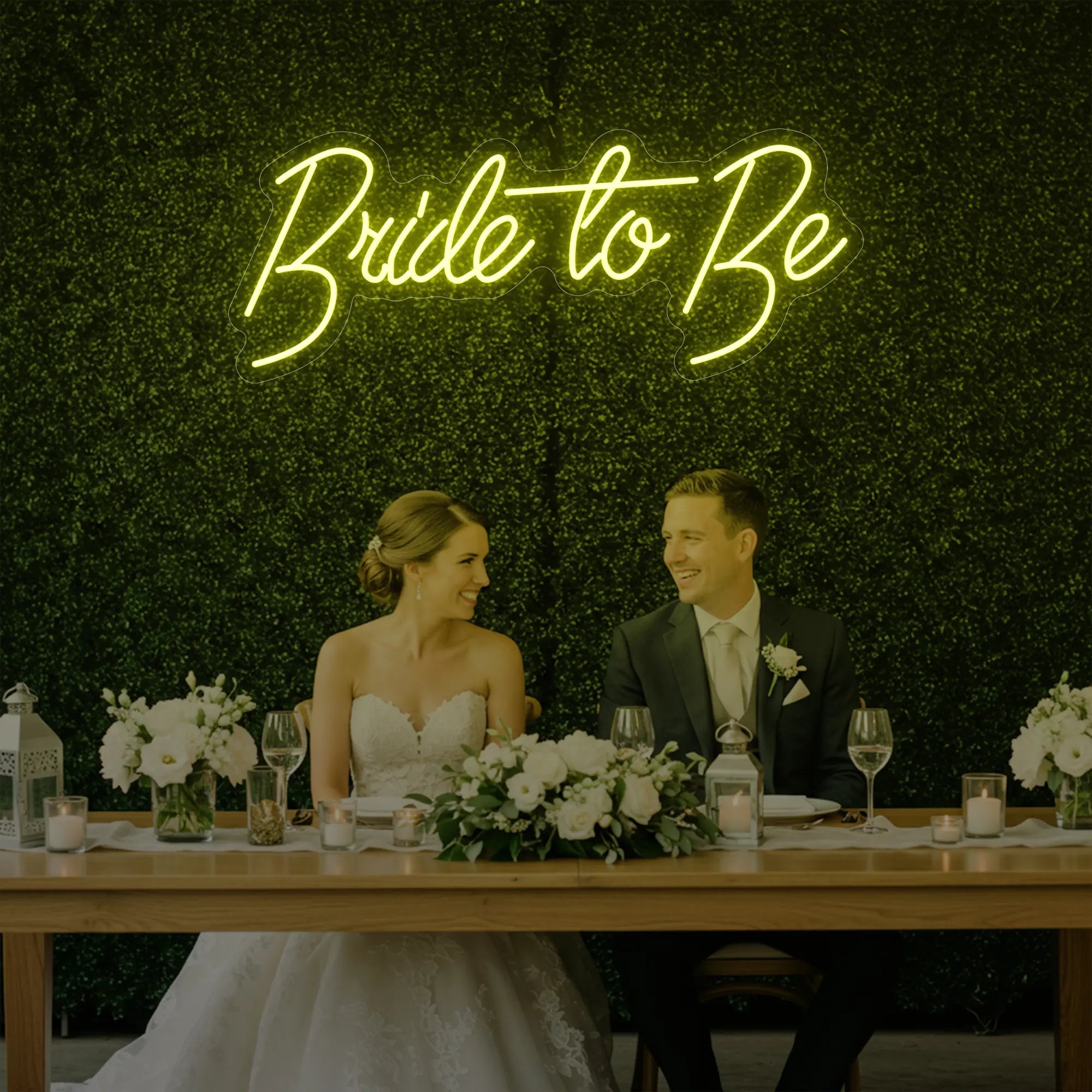Photo of the 'Bride To Be' neon sign glowing in lemon yellow against a styled interior wall.